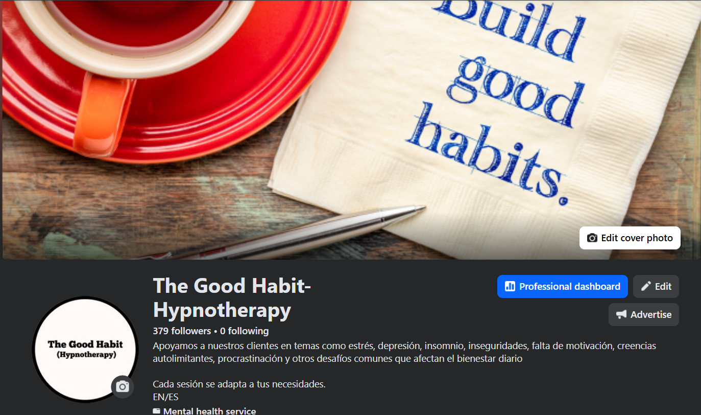 A red plate with a red cup of tea or coffee, a silver pen, and a paper napkin with blue text reading 'Build good habits' on a wooden table.