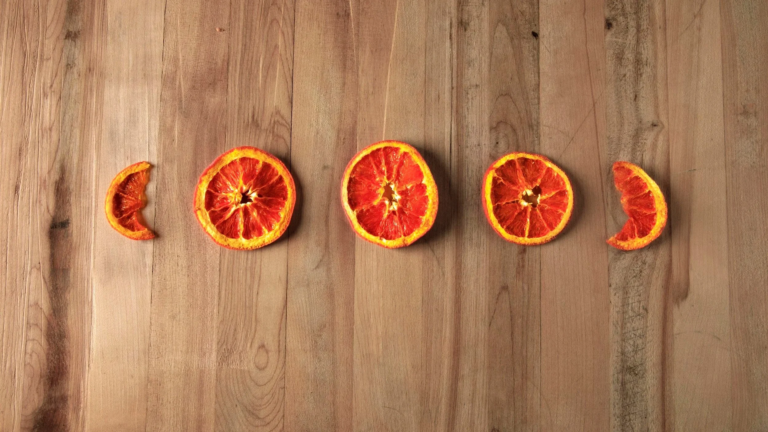Dehydrated Orange Slices arranged as a parenthetical statment.