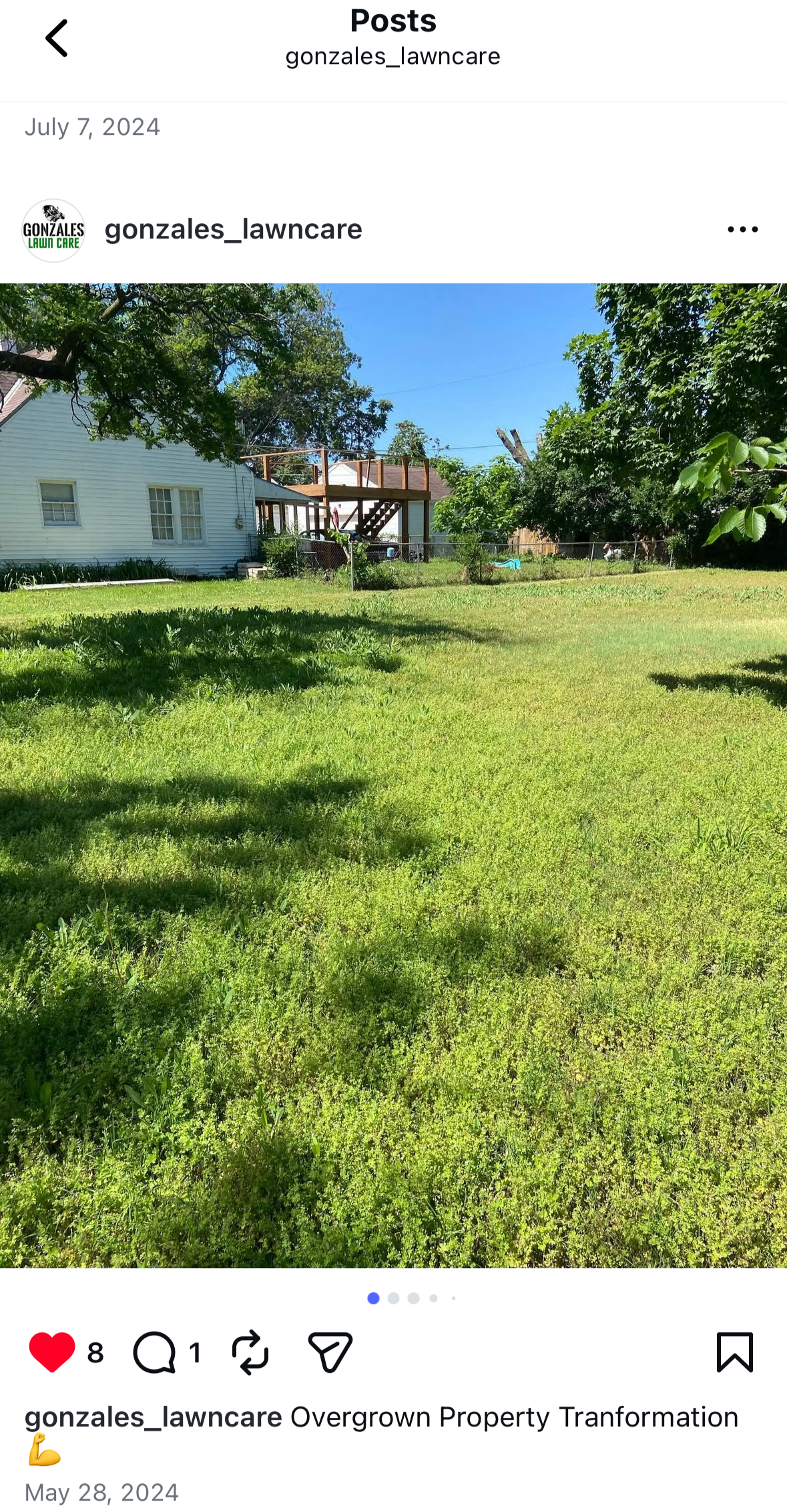 A backyard with overgrown grass and weeds, a white house, and a wooden deck under construction in the background.