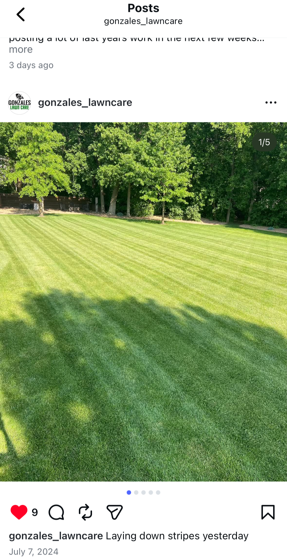 Freshly mowed lawn with green grass featuring striped pattern, with lush trees in the background.