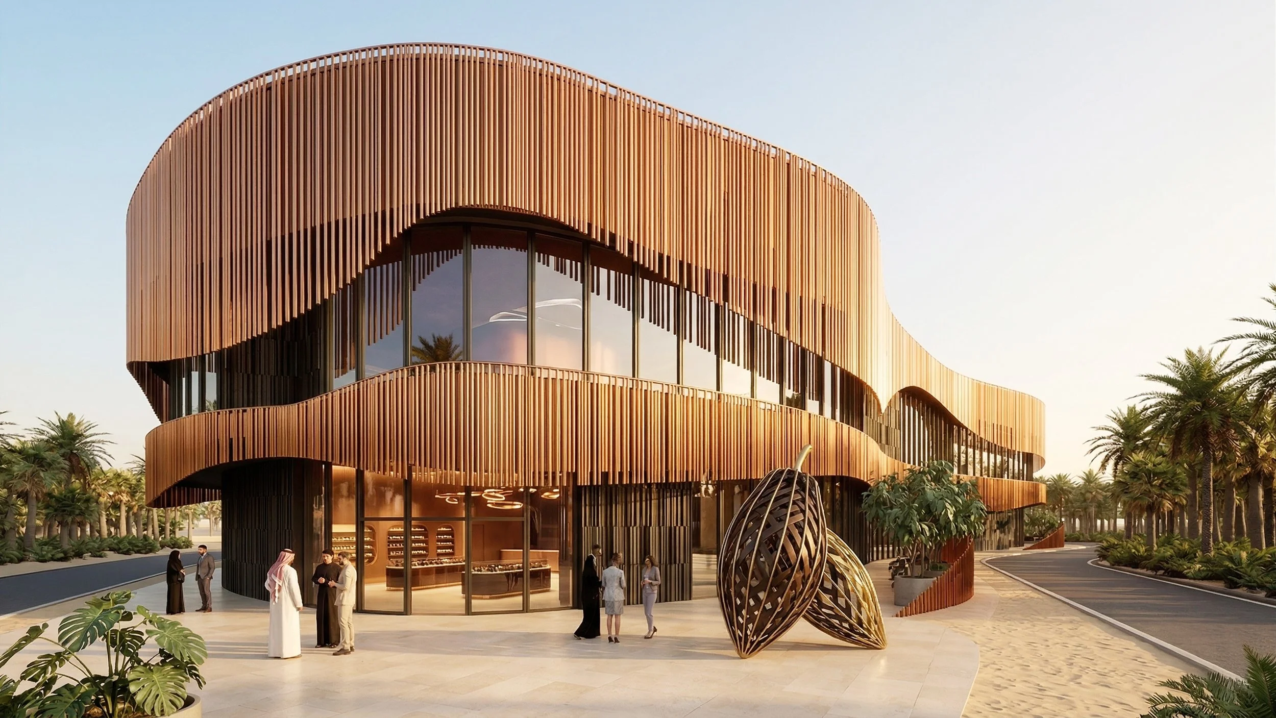 Modern building with a copper-colored curved exterior, large glass windows, and surrounded by palm trees, with a group of people standing outside.
