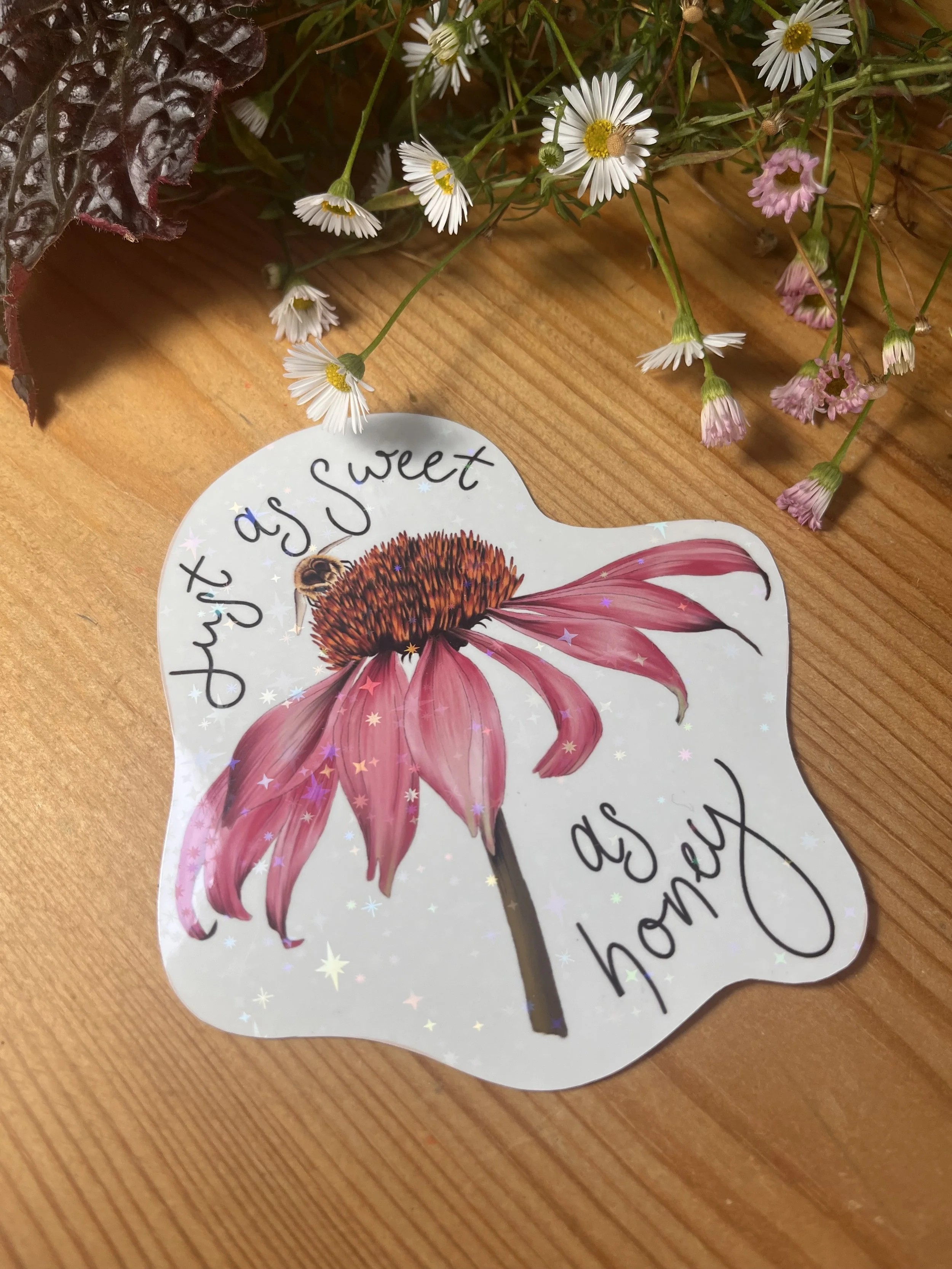 Holographic link daisy flowers, the sticker is tilted to show off the holographic sparkles on the sticker.