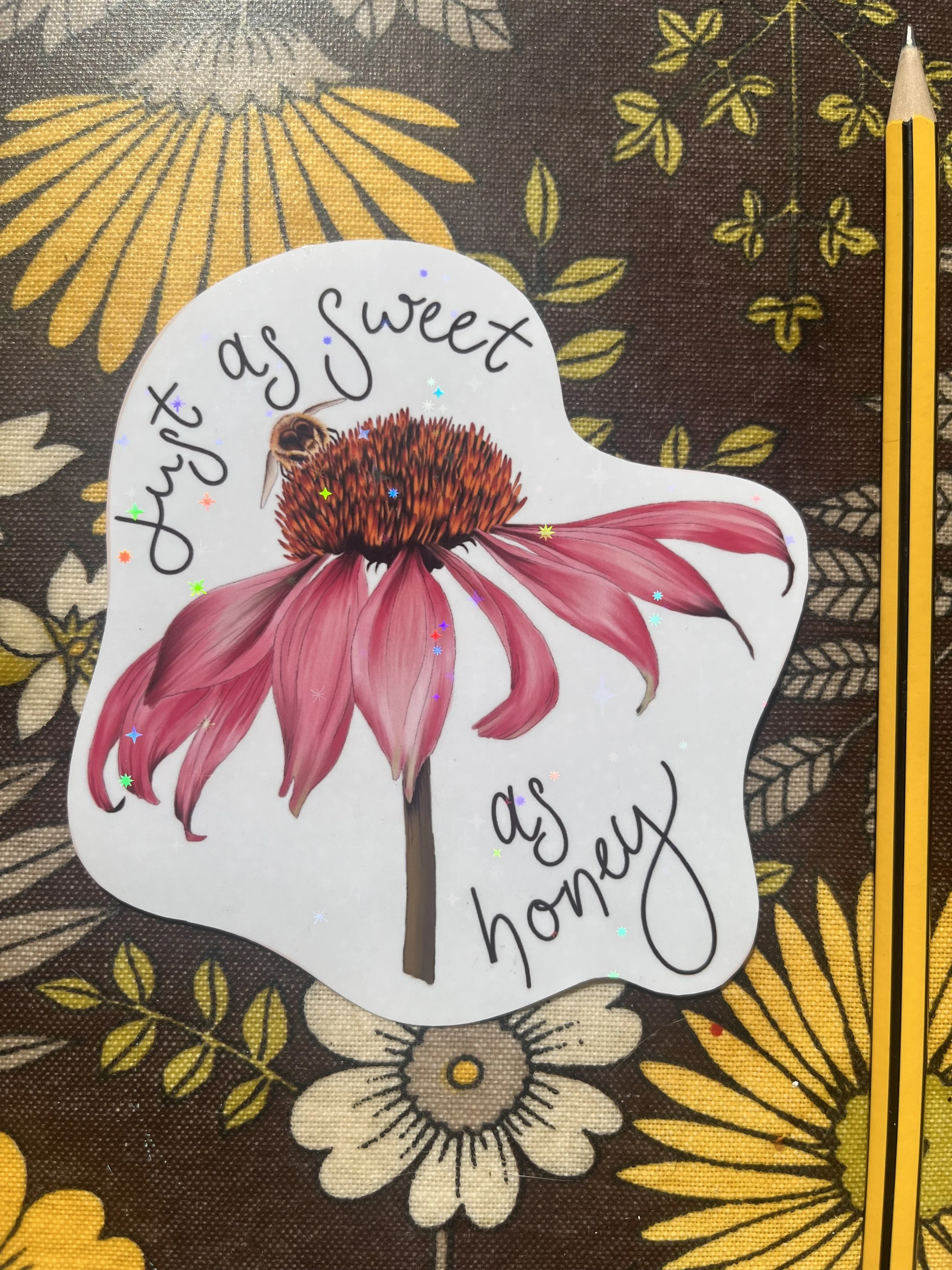Pink echinacea sticker photographed on a floral tray with a pencil to one side.
