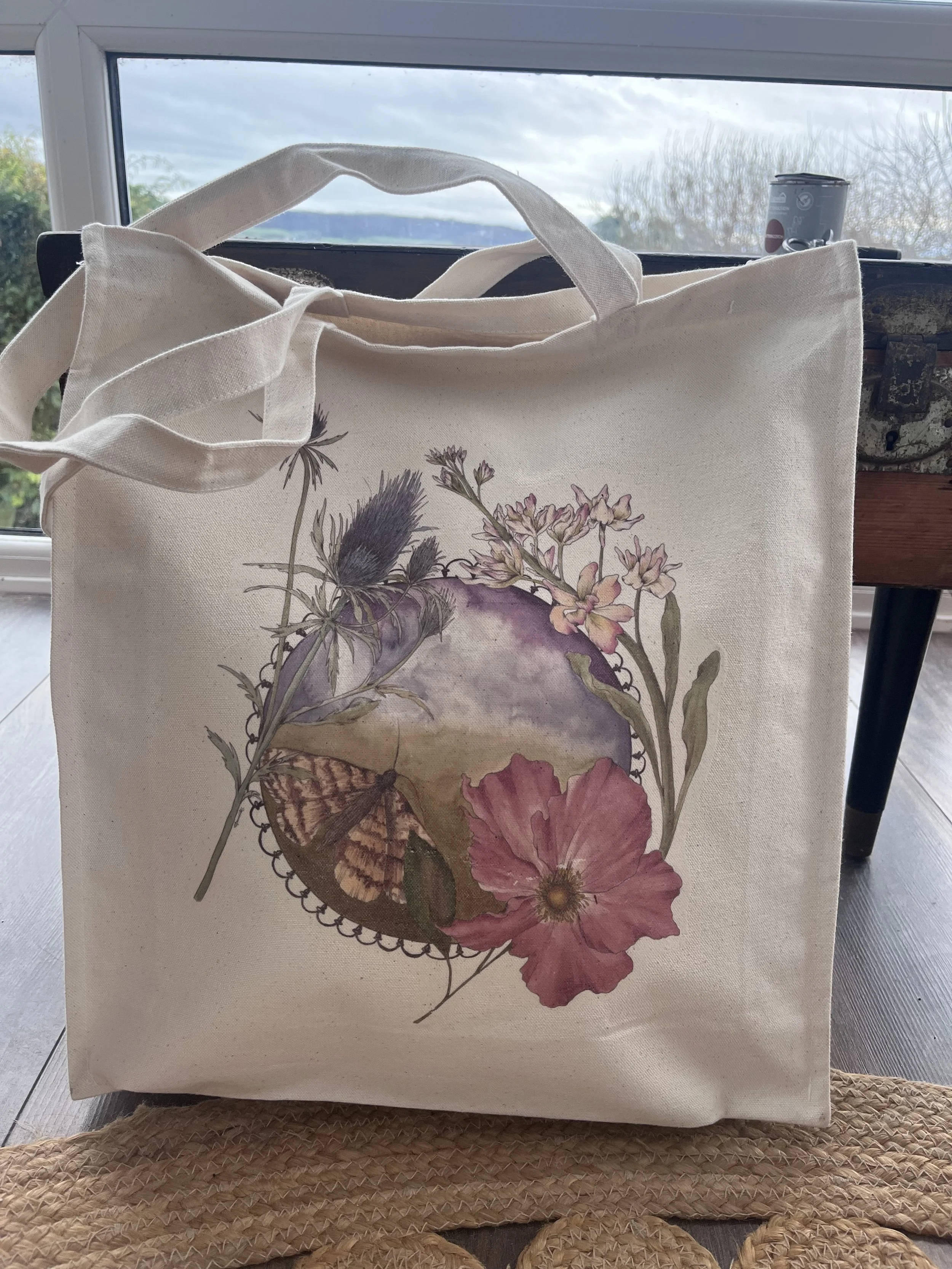 Moth and floral themed tote bag.