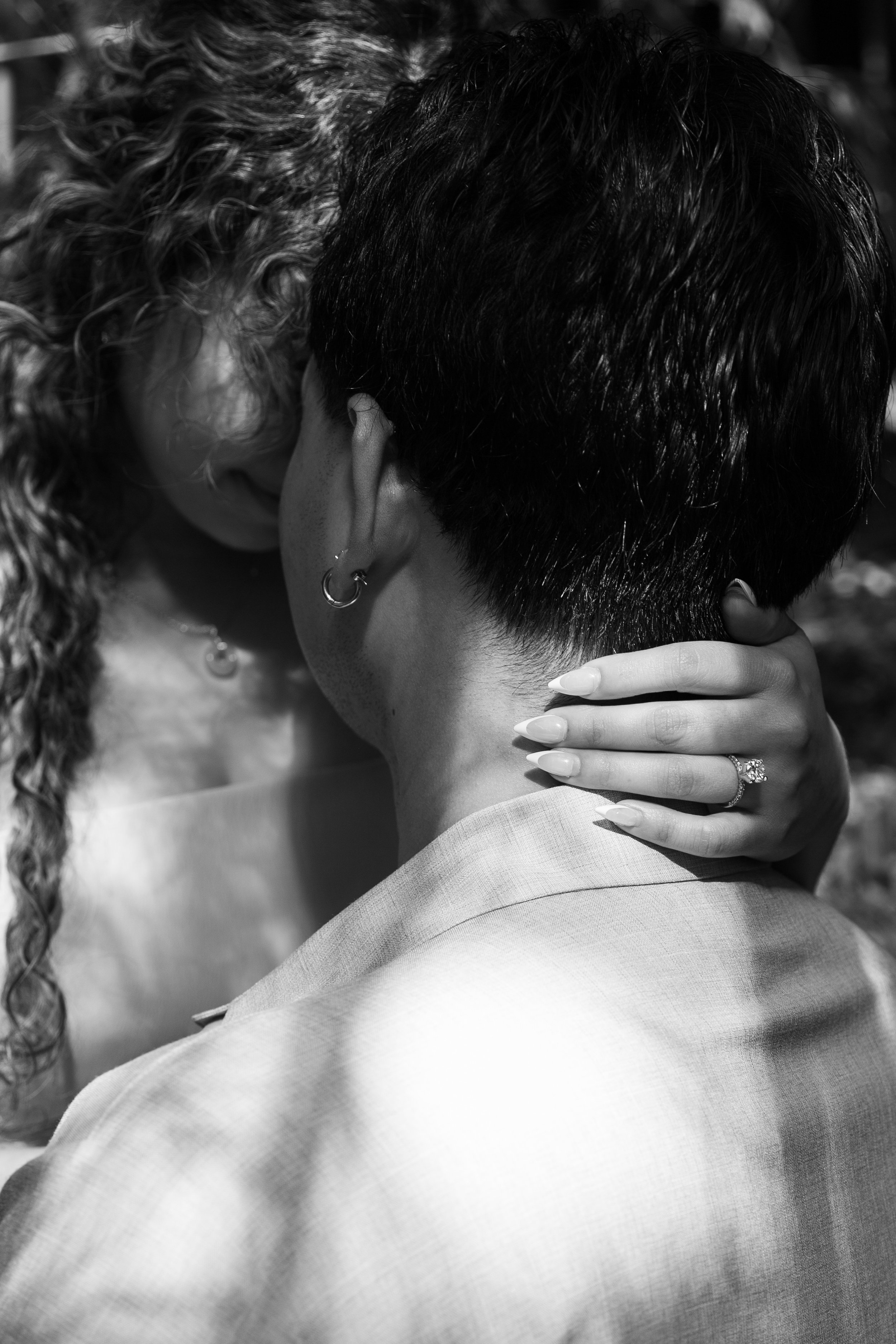 Close detail of engagement ring as the couple touches foreheads during an engagement session at The Huntington Library.