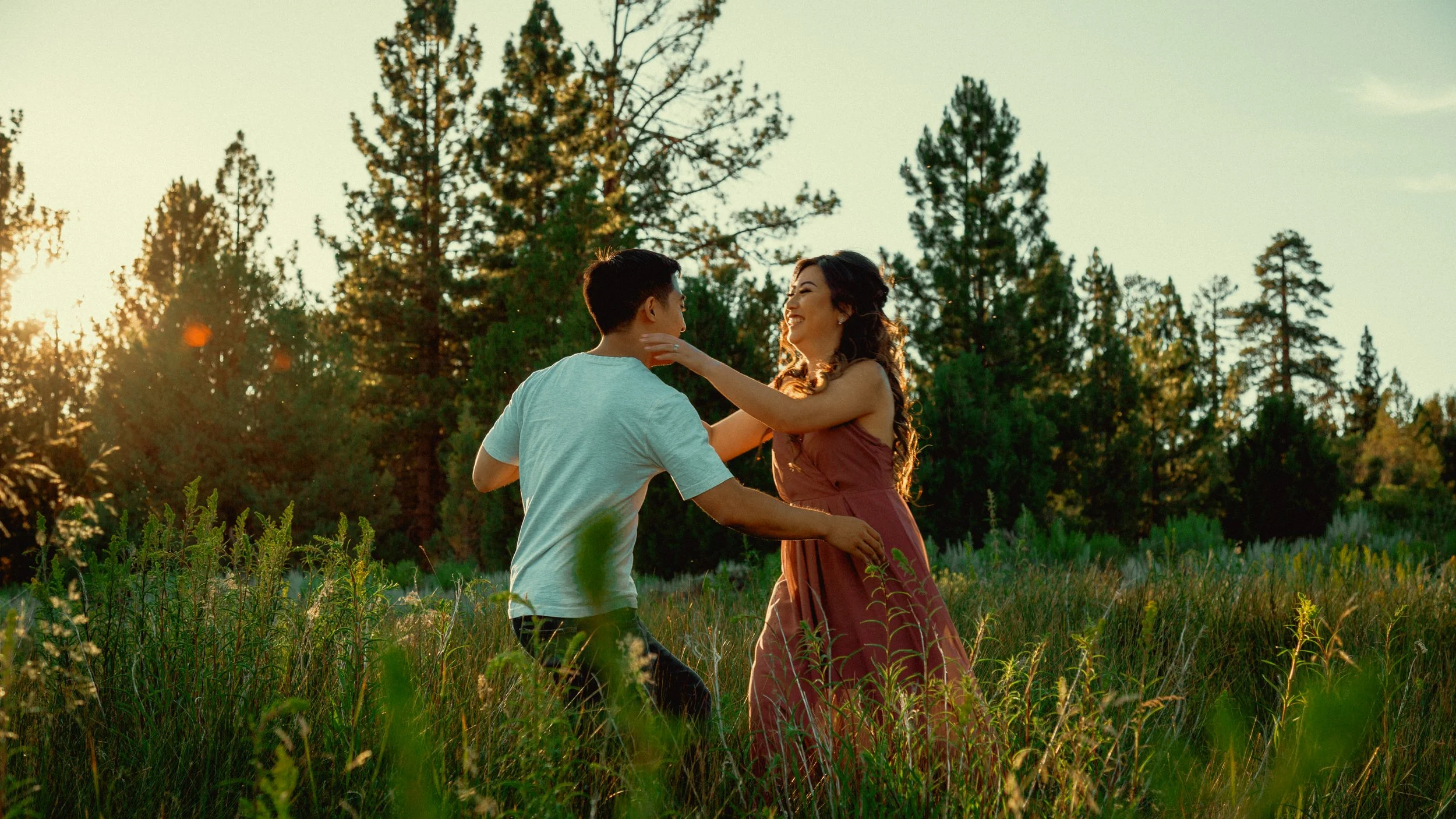 Couple running toward each other at sunset during an engagement session at Big Bear Lake.