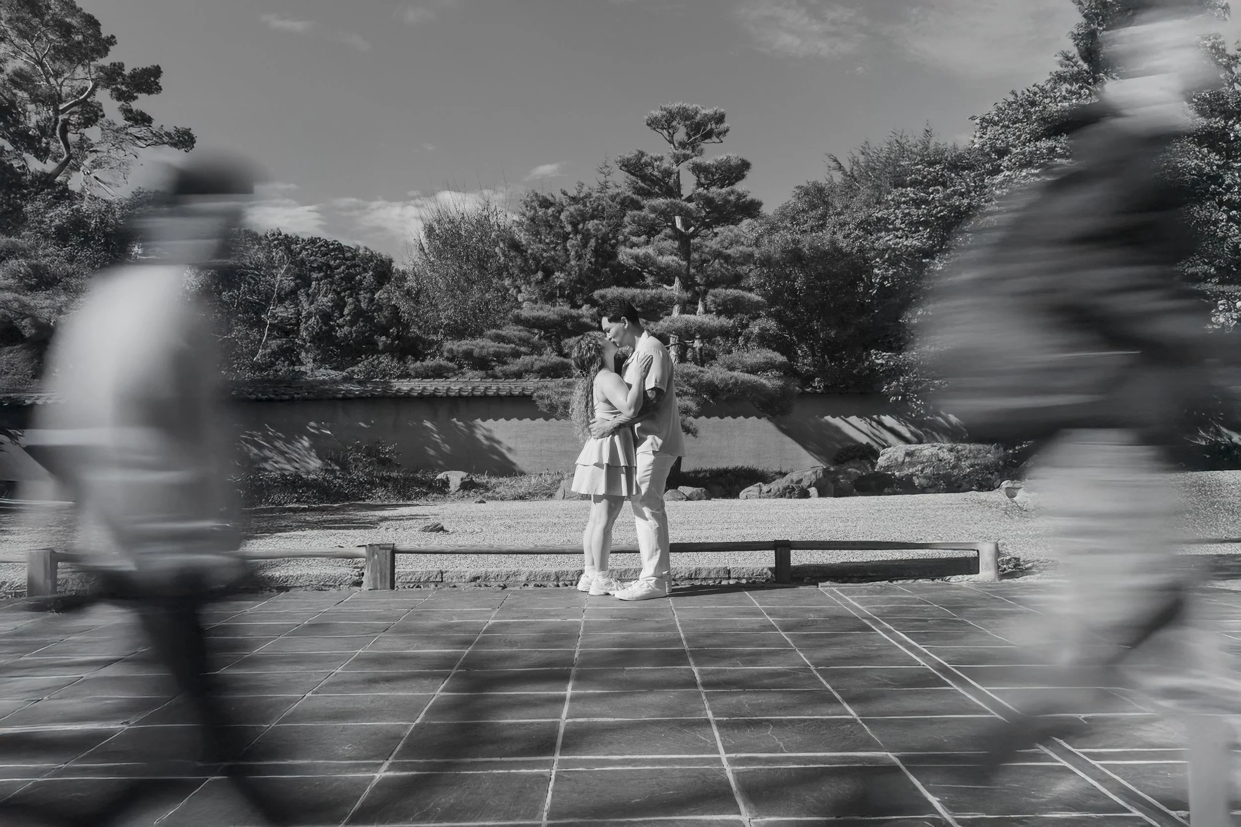 Couple embracing in the zen garden at The Huntington Library during their engagement session.