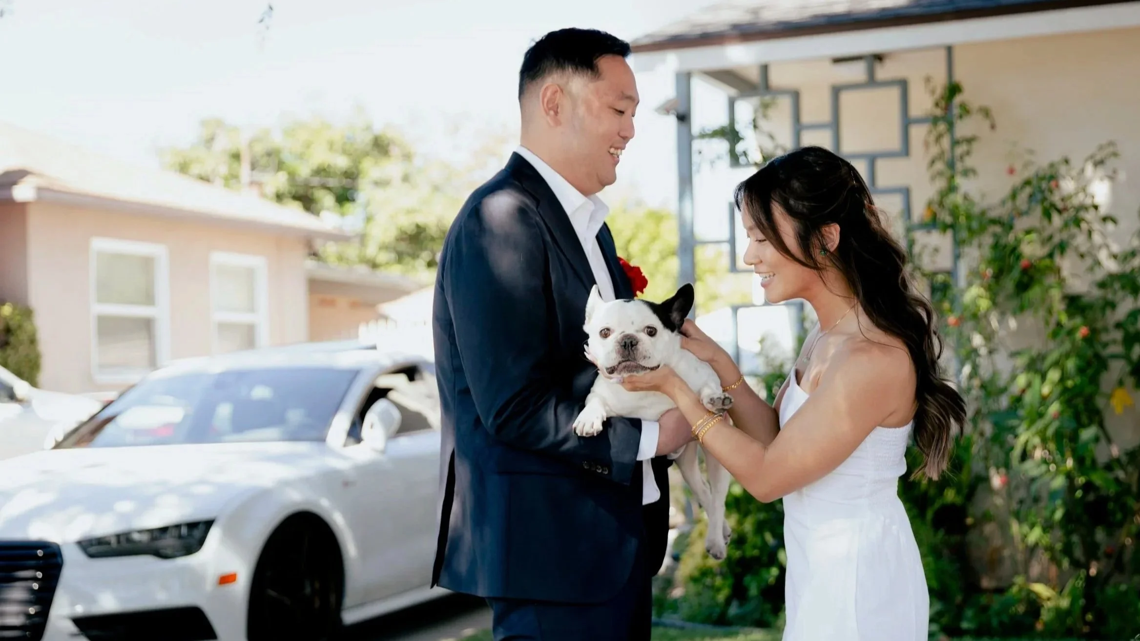 Couple holding their dog during a tea ceremony portrait in Los Angeles.