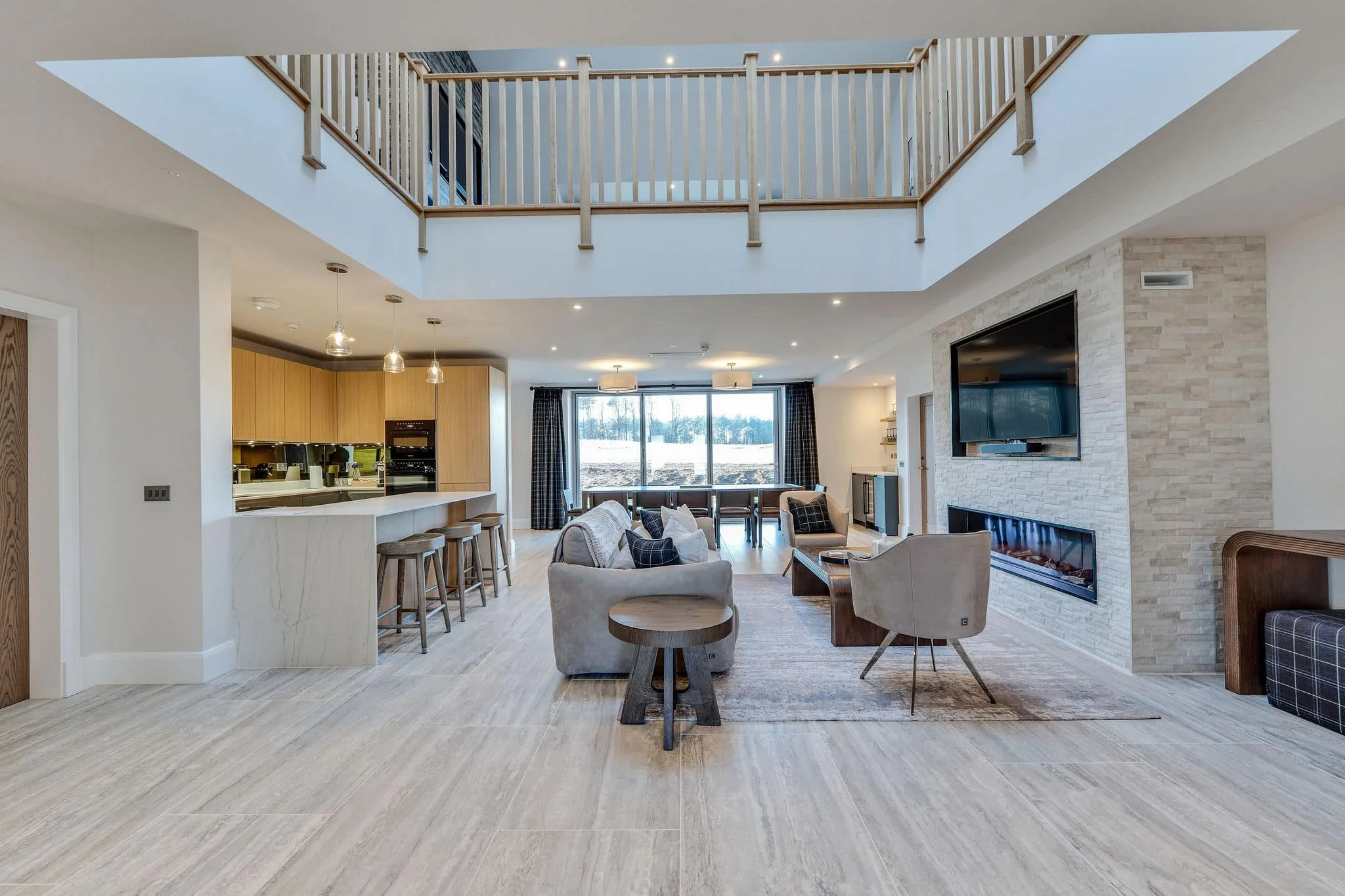 Open-plan living, kitchen and dining space in a high-end Scottish estate home project.