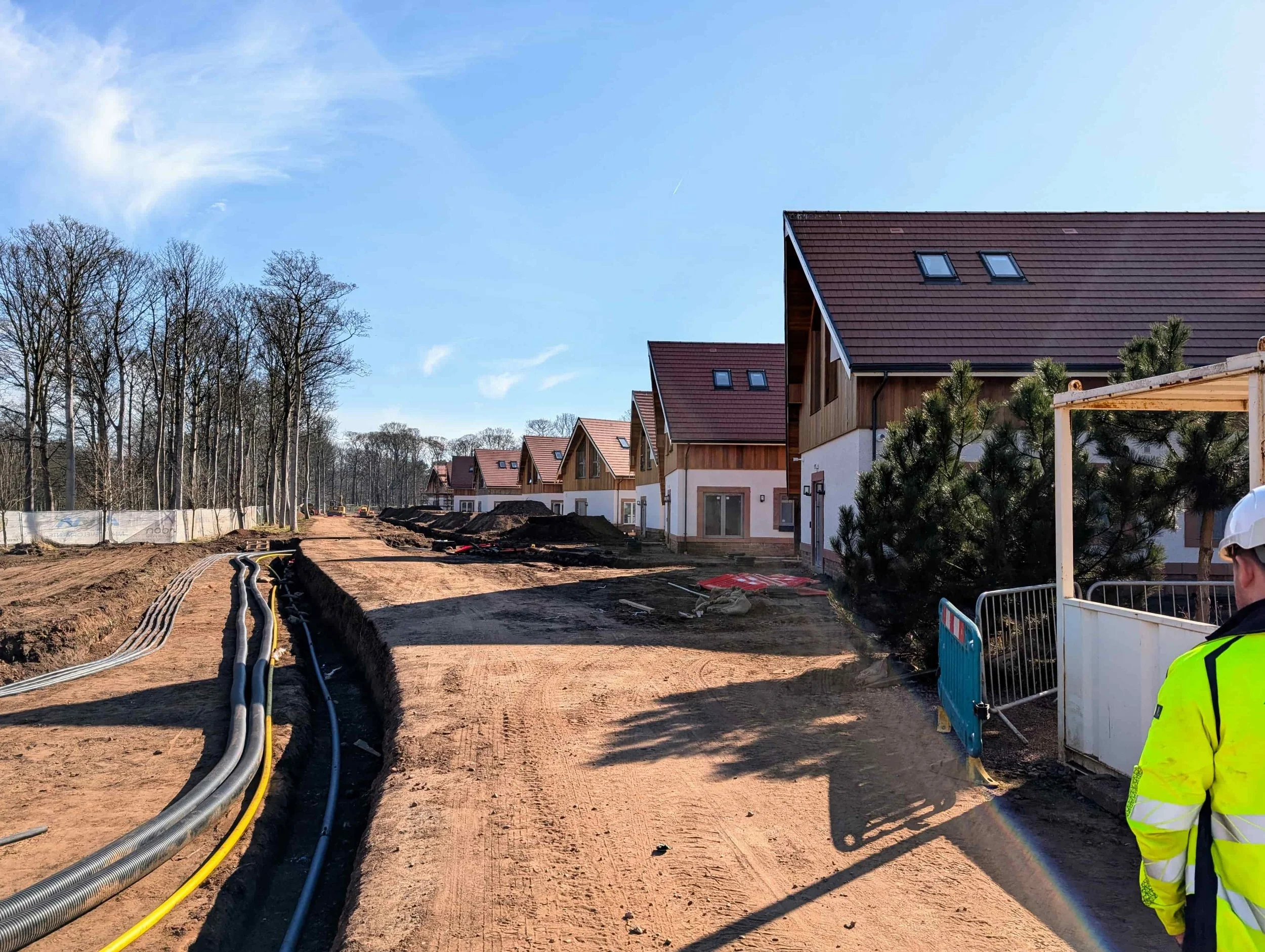 Residential housing development under construction with underground services installation.