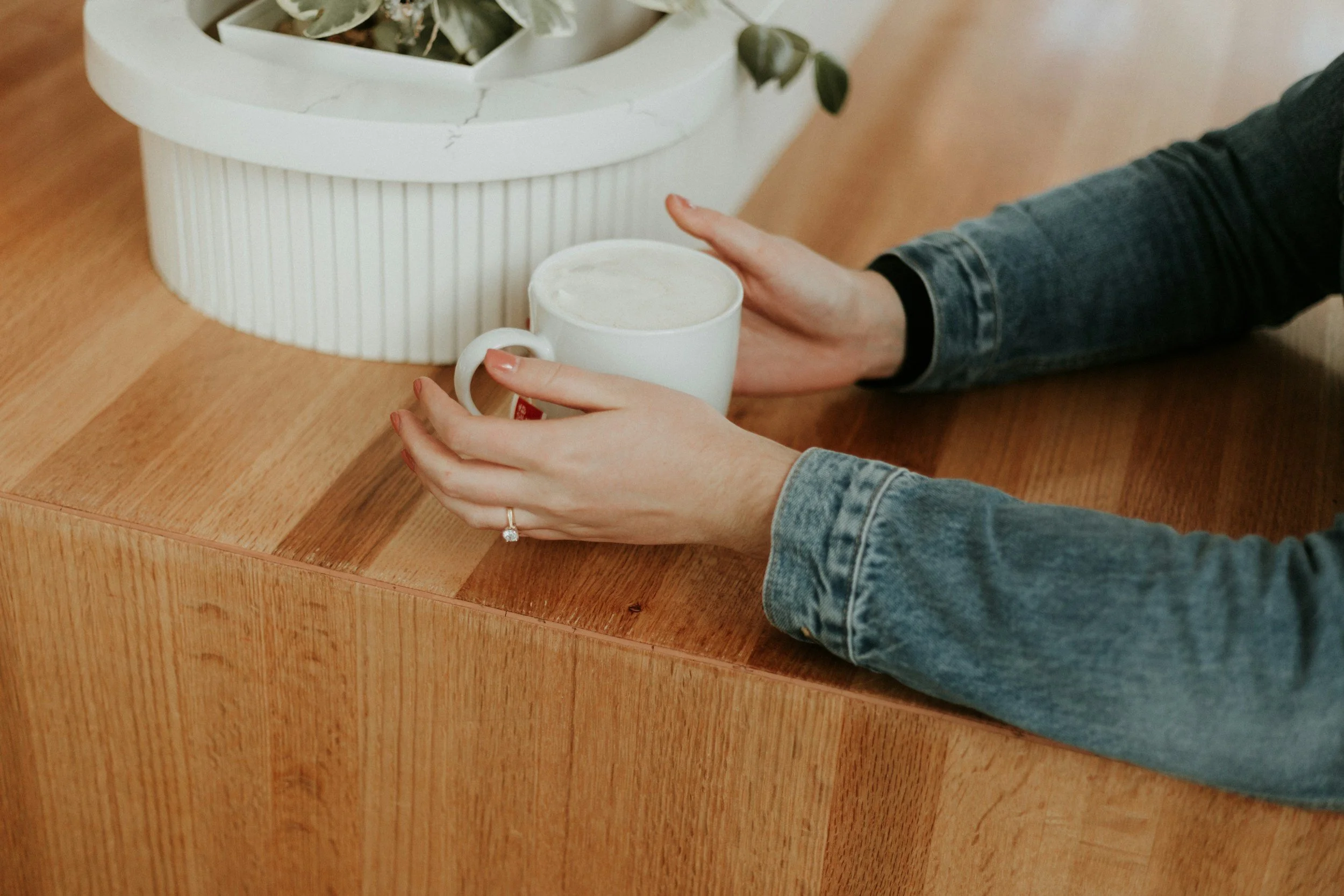 two hands holding coffee mug