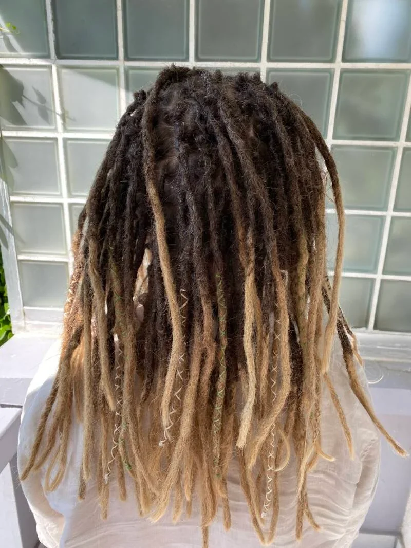 Haar mit Dreadlocks in verschiedenen Blond- und Brauntönen.