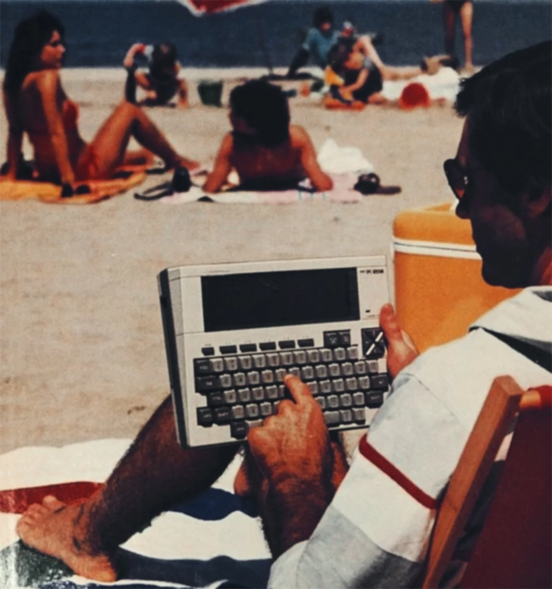 A man sitting on a beach chair using a portable electronic calculator device, with people on a lazy beach day in the background.