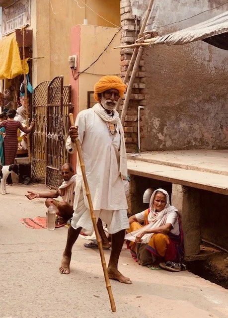 An elderly man with a beard, wearing traditional Indian clothing and an orange turban, Vrindavan yogi rishikesh ohmat travel himalaya debbie liladhar yoga bhakti india