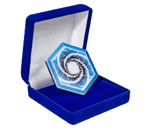 A decorative hexagonal object with a blue and white swirl pattern inside a blue velvet box with a cushioned interior.