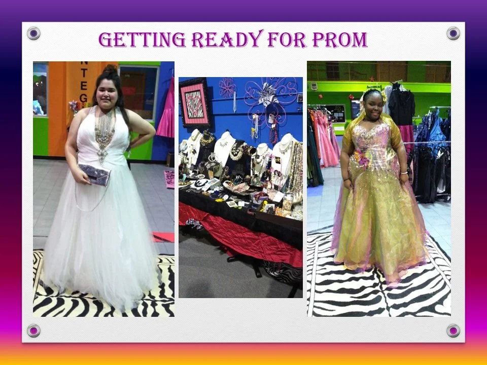 Two women in prom dresses shopping at a store, with a jewelry display and clothing racks in the background.