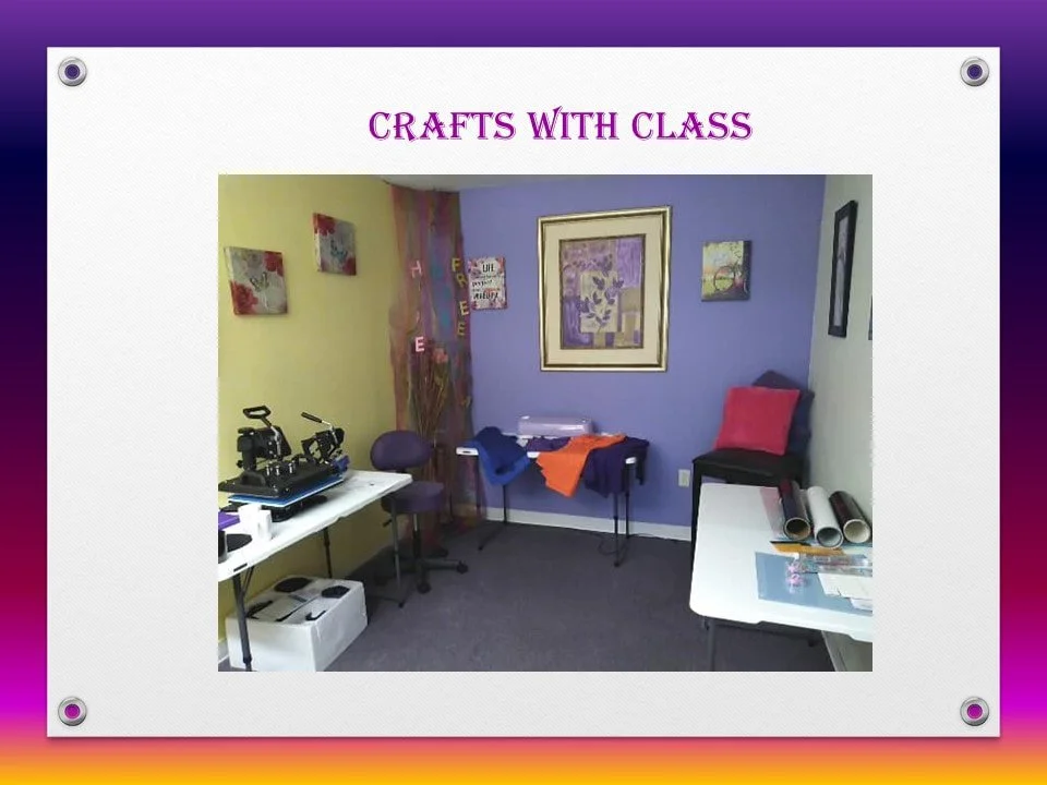Room decorated for a crafting class with tables and various craft supplies, colorful walls, and framed artwork.