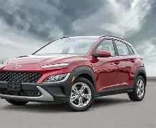 Red SUV parked outdoors under cloudy sky