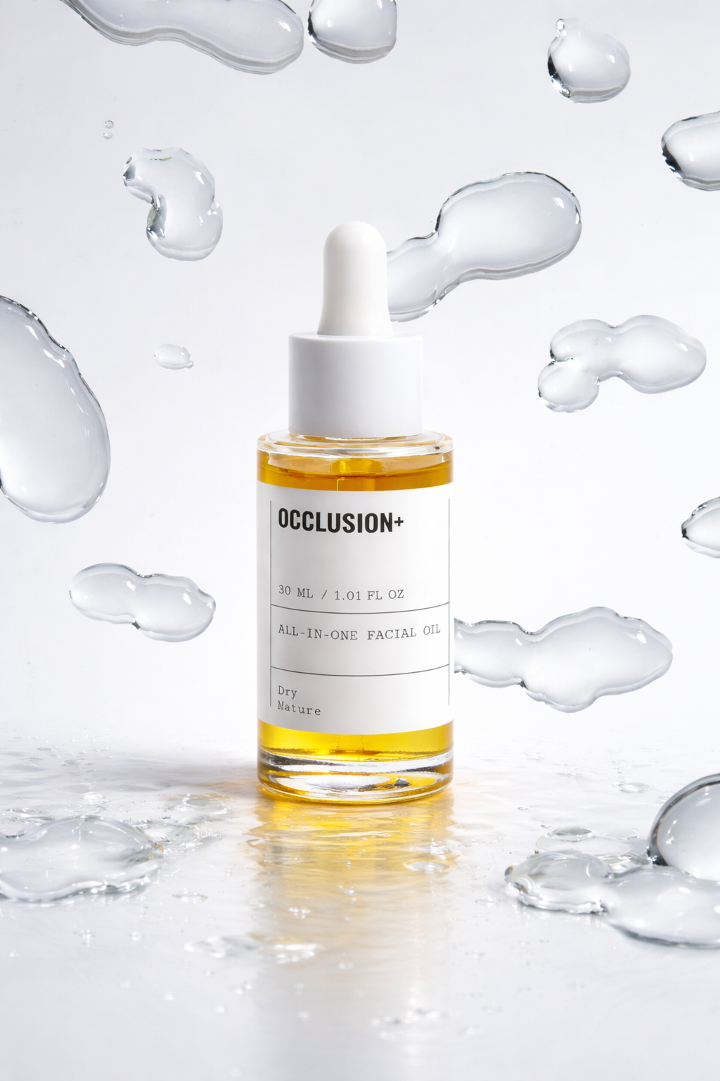 A clear glass bottle of facial oil labeled 'OCCLUSION+', with a white dropper cap, surrounded by floating and resting water droplets on a reflective surface.