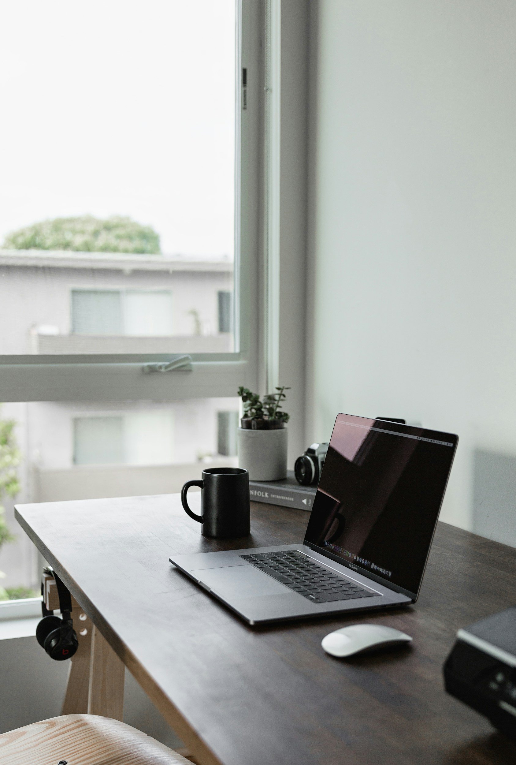 laptop on table with black coffee mug, emdr therapist northern colorado