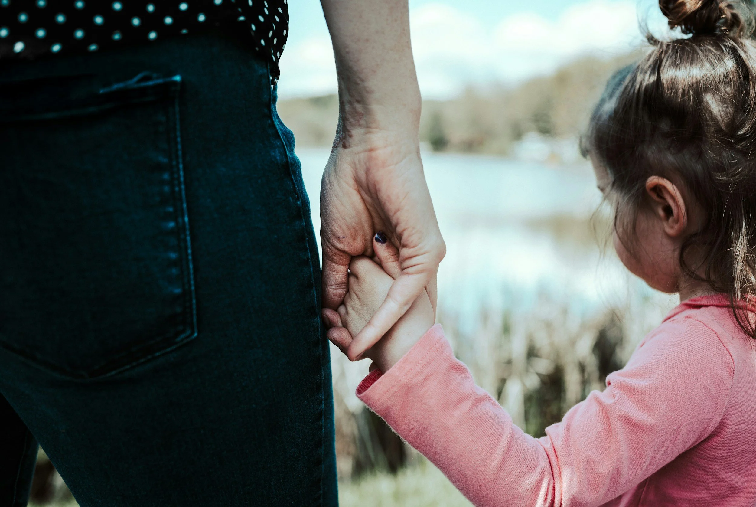 motherhood anxiety therapy, postpartum therapy for anxiety, mom and daughter holding hands