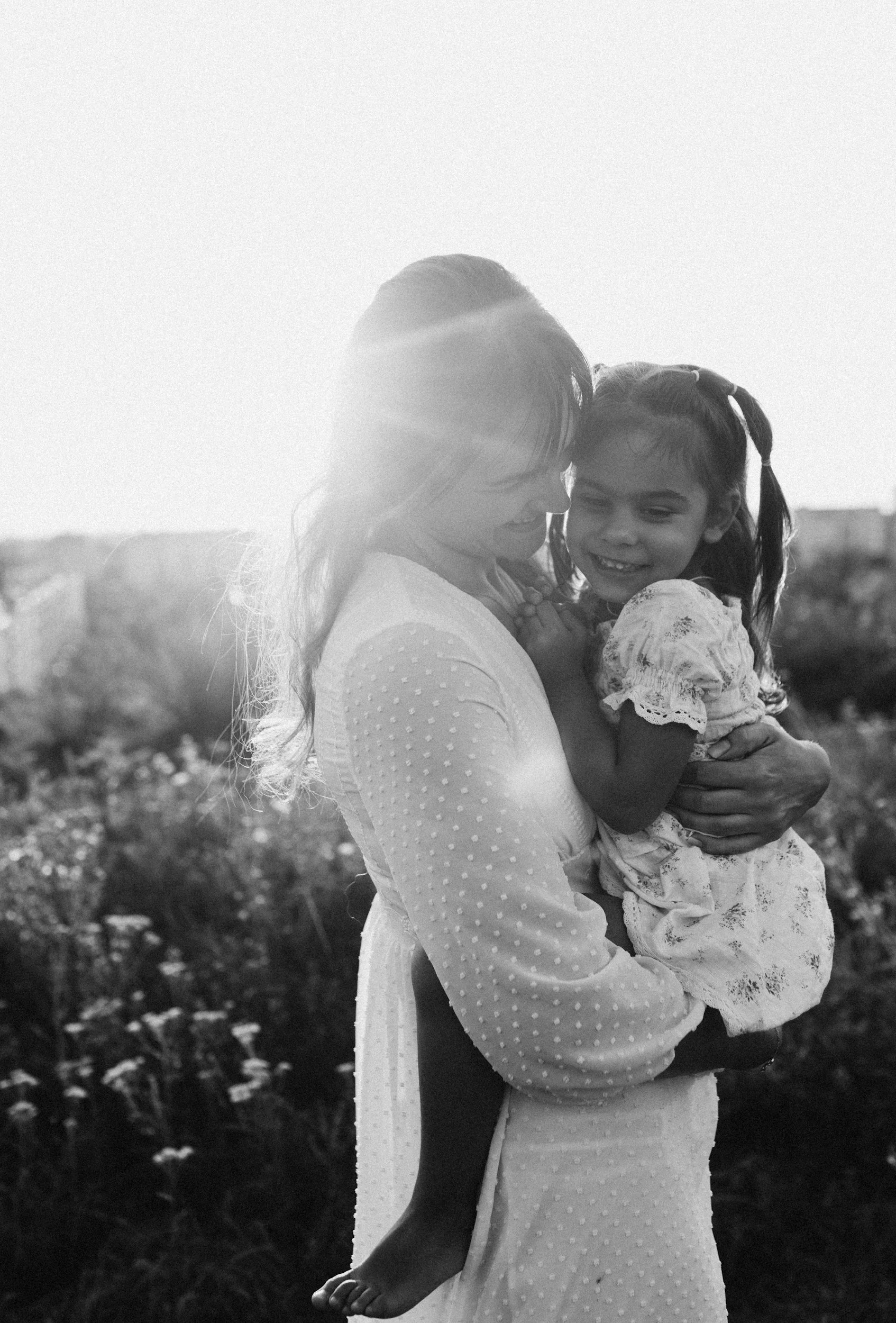 mother holding daughter in a field, birth trauma recovery, birth trauma therapy, birth trauma therapist fort collins