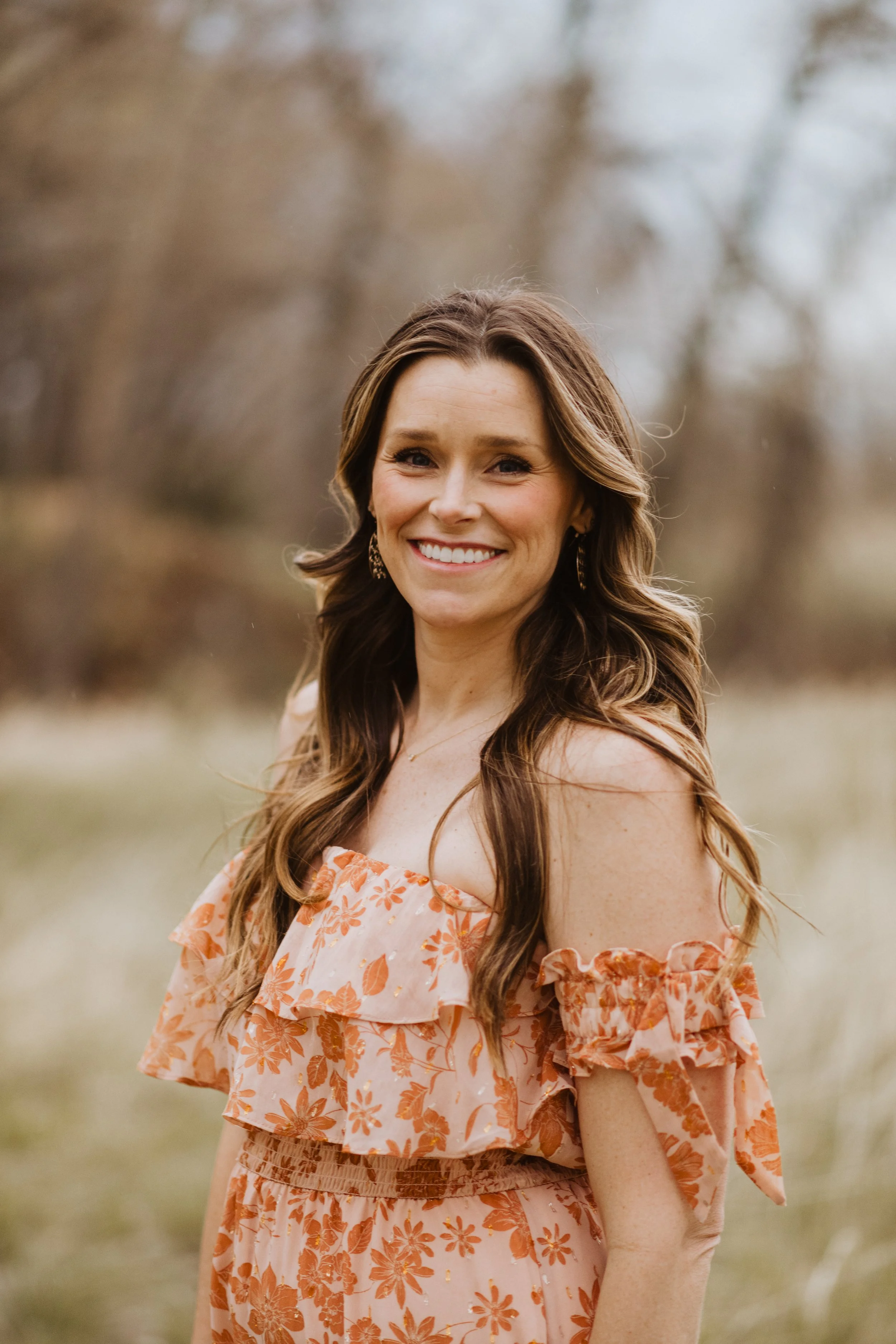 Fort Collins trauma expert, woman standing in field smiling
