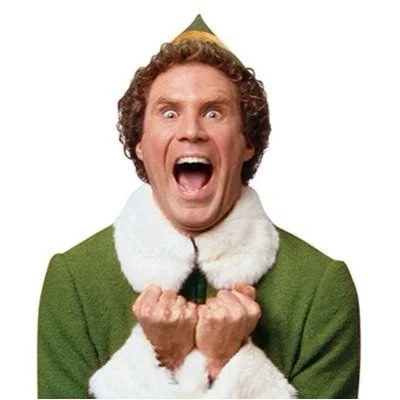 Man dressed as an elf with an excited or angry expression, mouth open, and fists clenched.