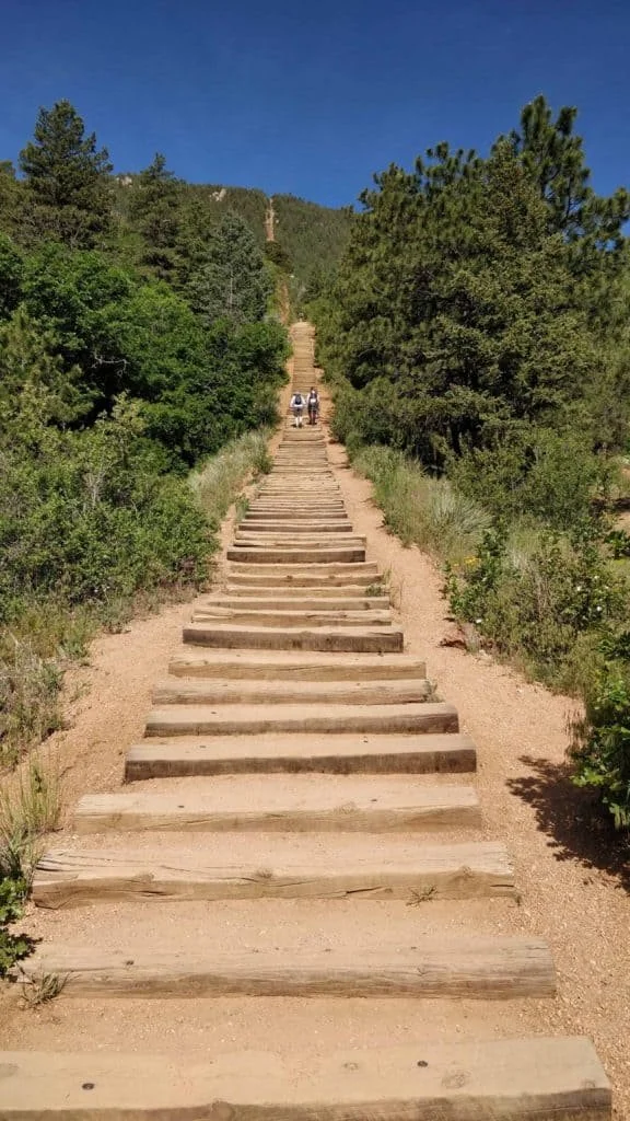 Wooden steps ascending a mountain trail representing the leadership journey with J Mikel Solutions executive coaching