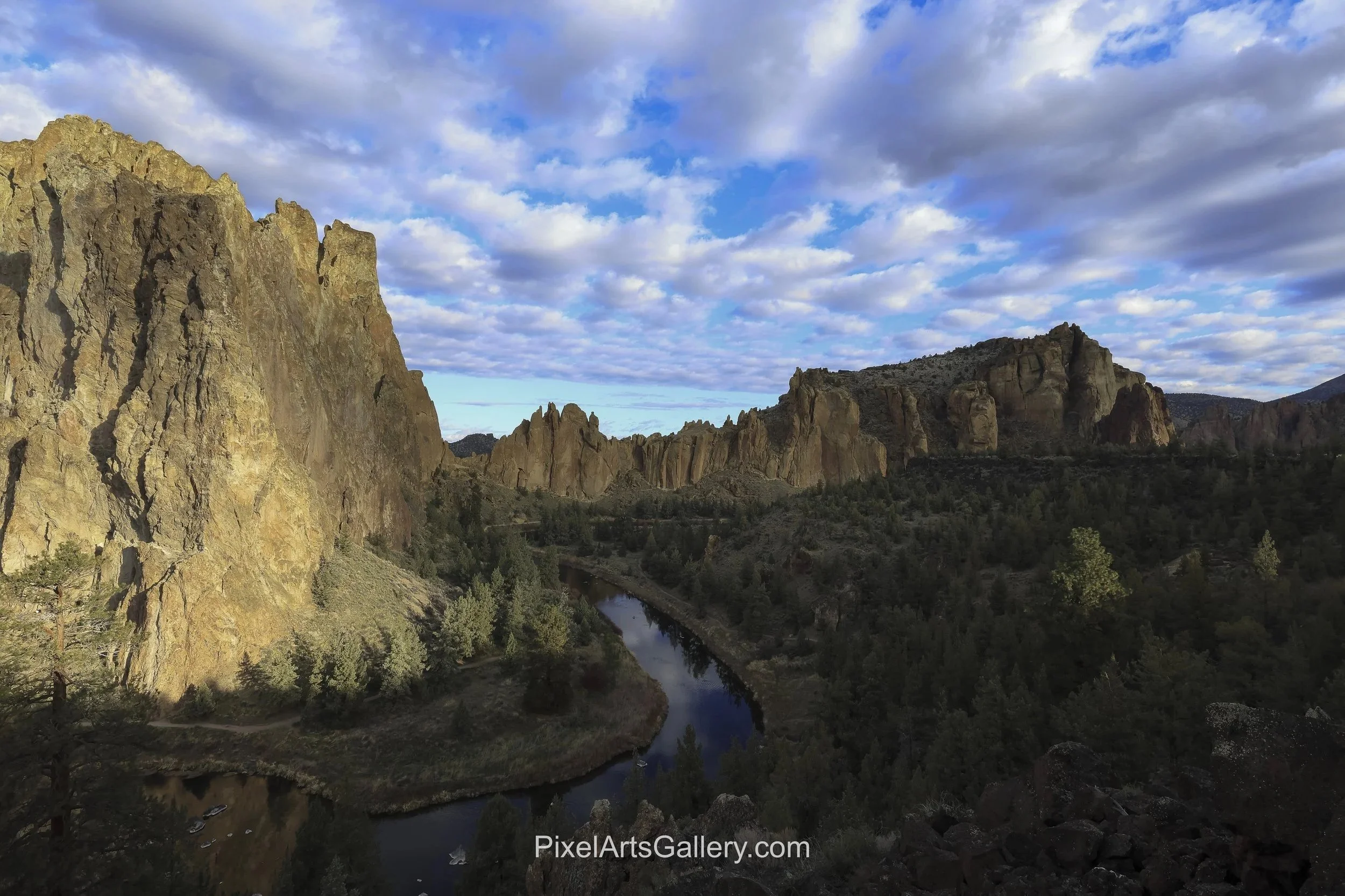 River Canyon - 

Warm morning sunlight strikes towering rock walls above the winding Crooked River. 