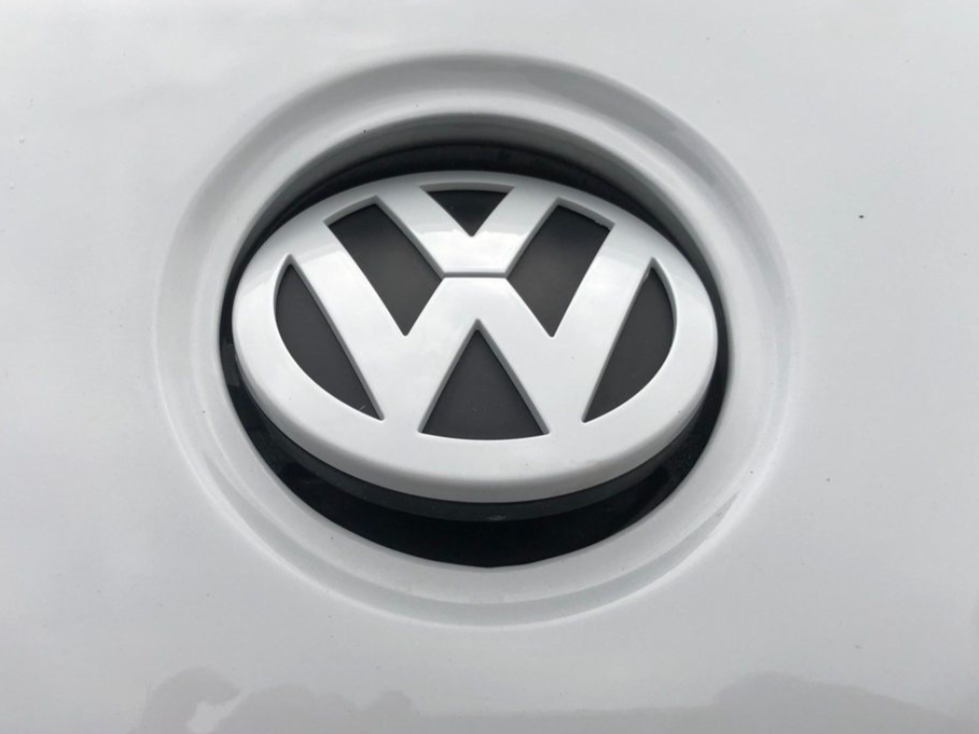 Close-up of the Volkswagen logo on a white vehicle.