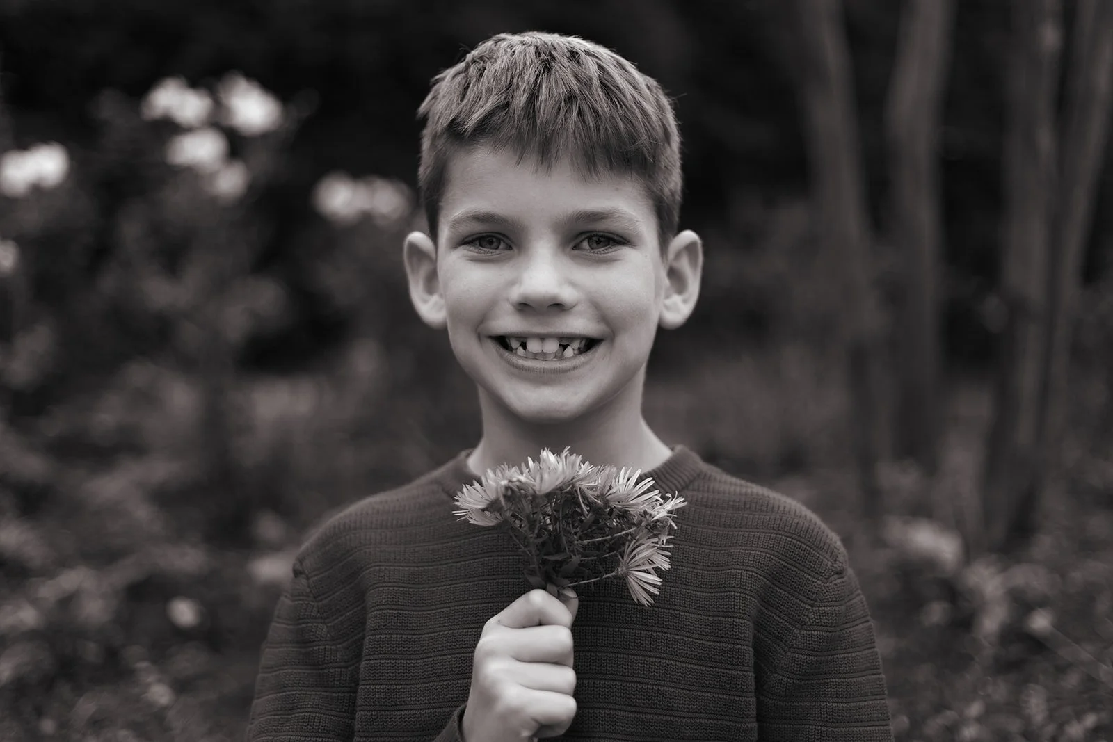 Relaxed family portrait with parents and children in Bucks County, warm tones and genuine connection captured naturally