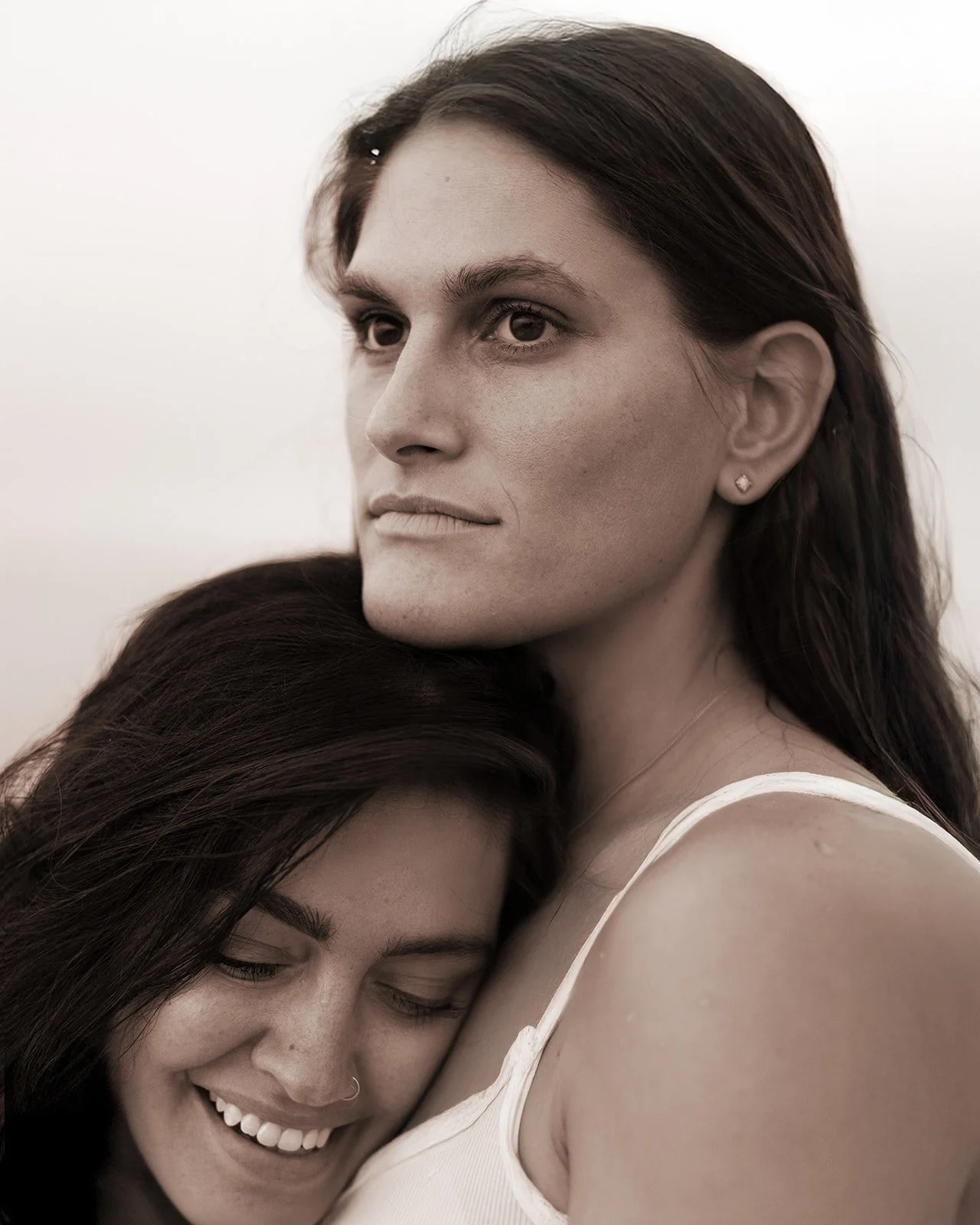 Romantic LGBTQ+ couples photography in Cape Cod with soft evening light and natural, unposed connection