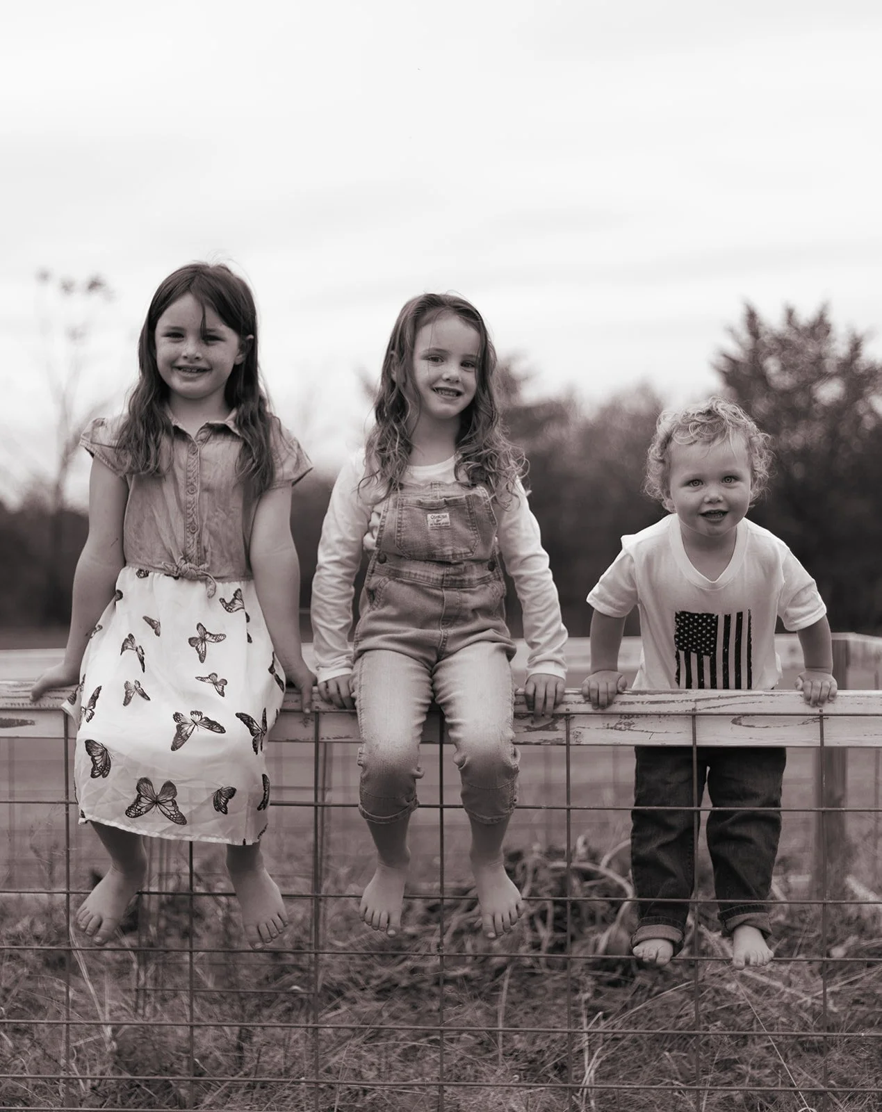 Family walking through their property with gardens and open space in Bucks County, natural and unposed photography