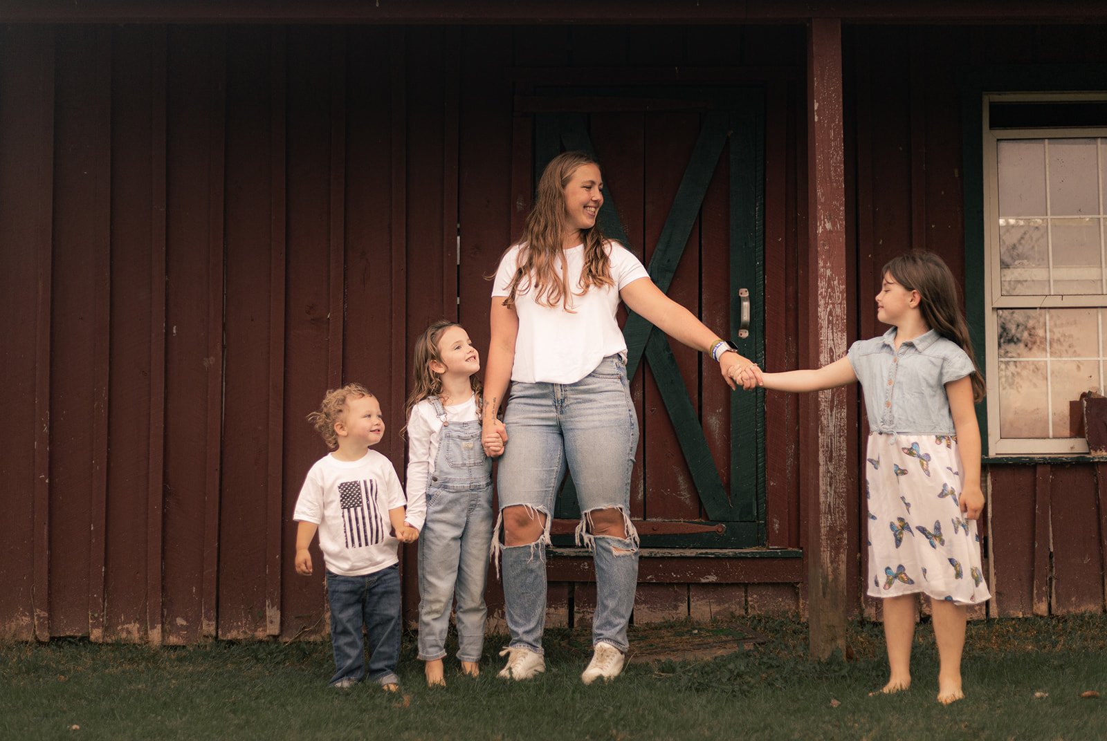 Wide outdoor family portrait with horse farms in the background in Bucks County, natural light and open landscape