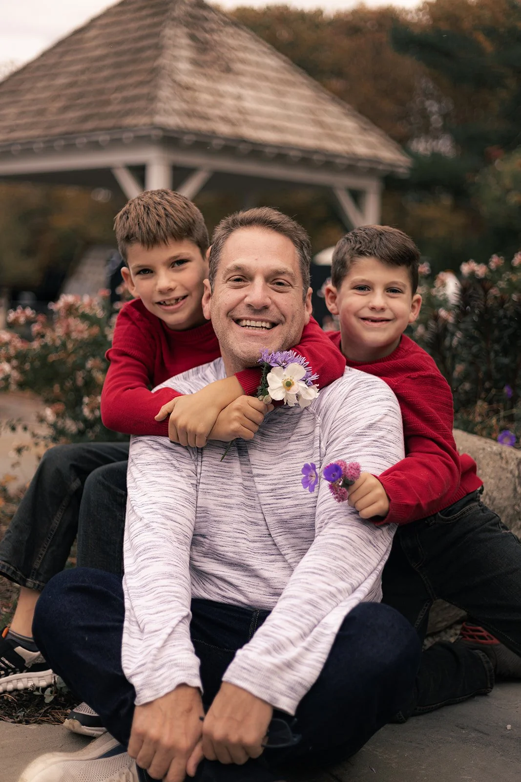 Family of four walking together outdoors during a relaxed fall session in Doylestown, candid and natural family photography