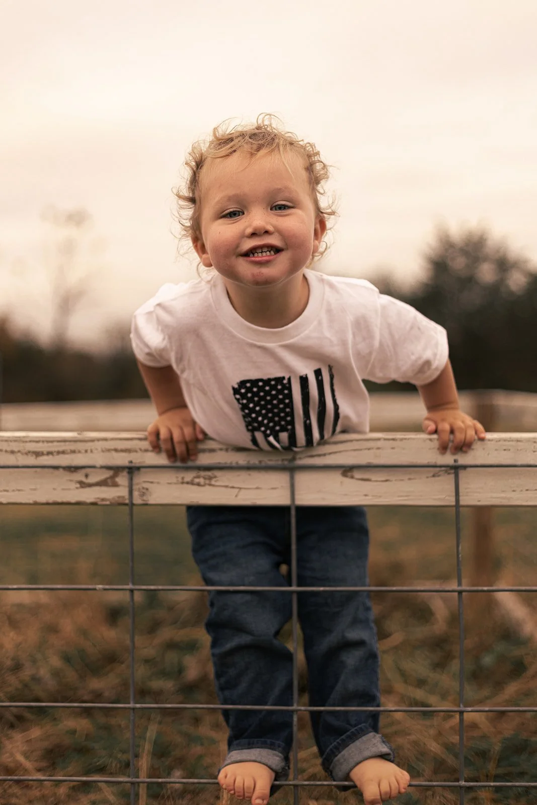 Candid moment of siblings playing together during an at-home family session in Doylestown, PA