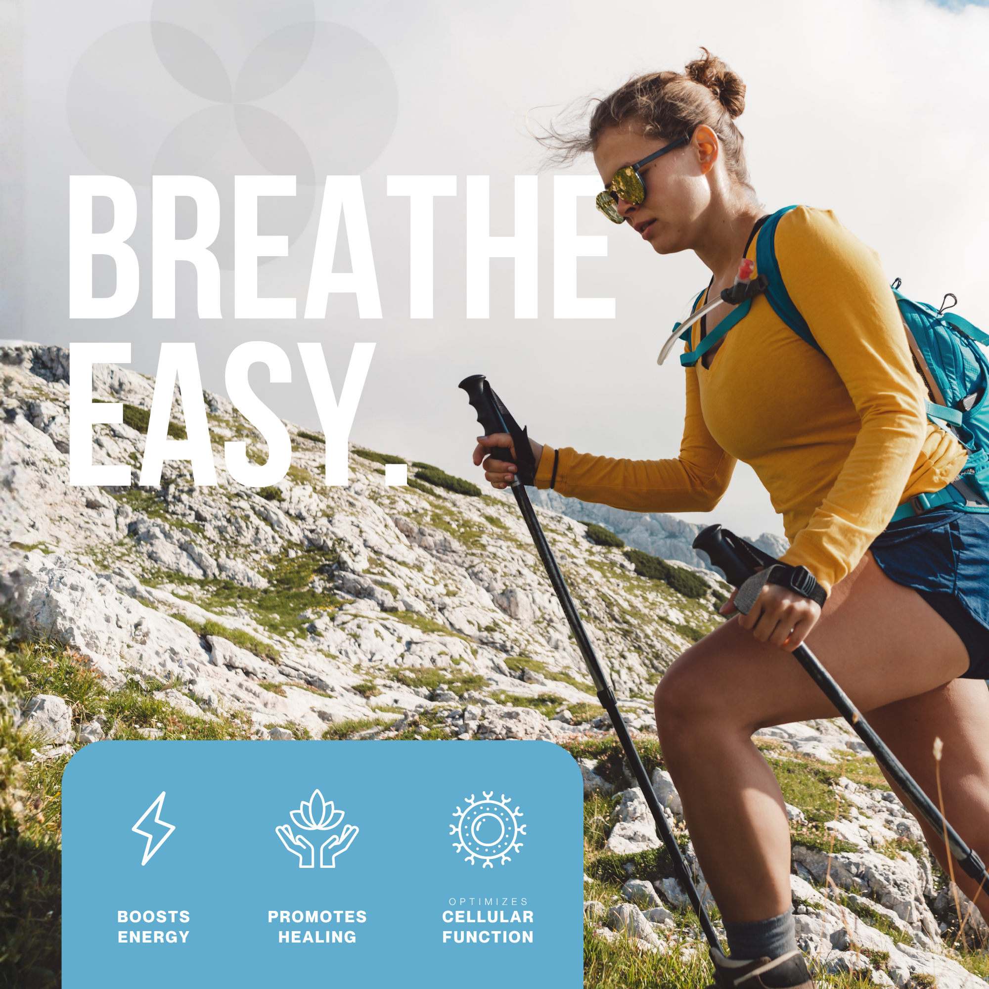 A woman hiking outdoors in a yellow long-sleeve shirt, black shorts, sunglasses, and a backpack, holding trekking poles on rocky terrain with mountains in the background, with overlaid text reading 'Breathe Easy' and icons related to energy, healing, and cellular function.