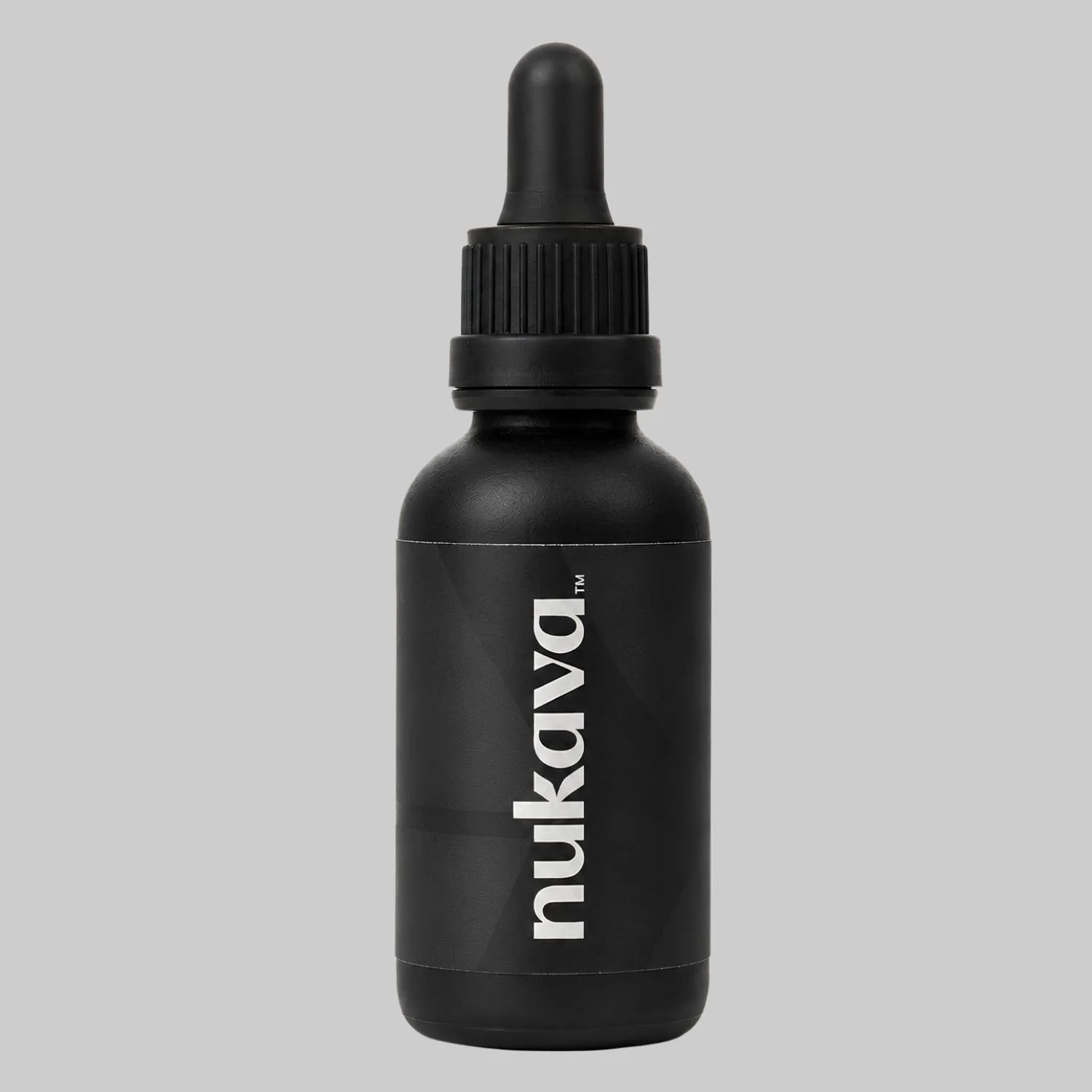 An amazon main image shot of a Nukava black dropper bottle on a grey background