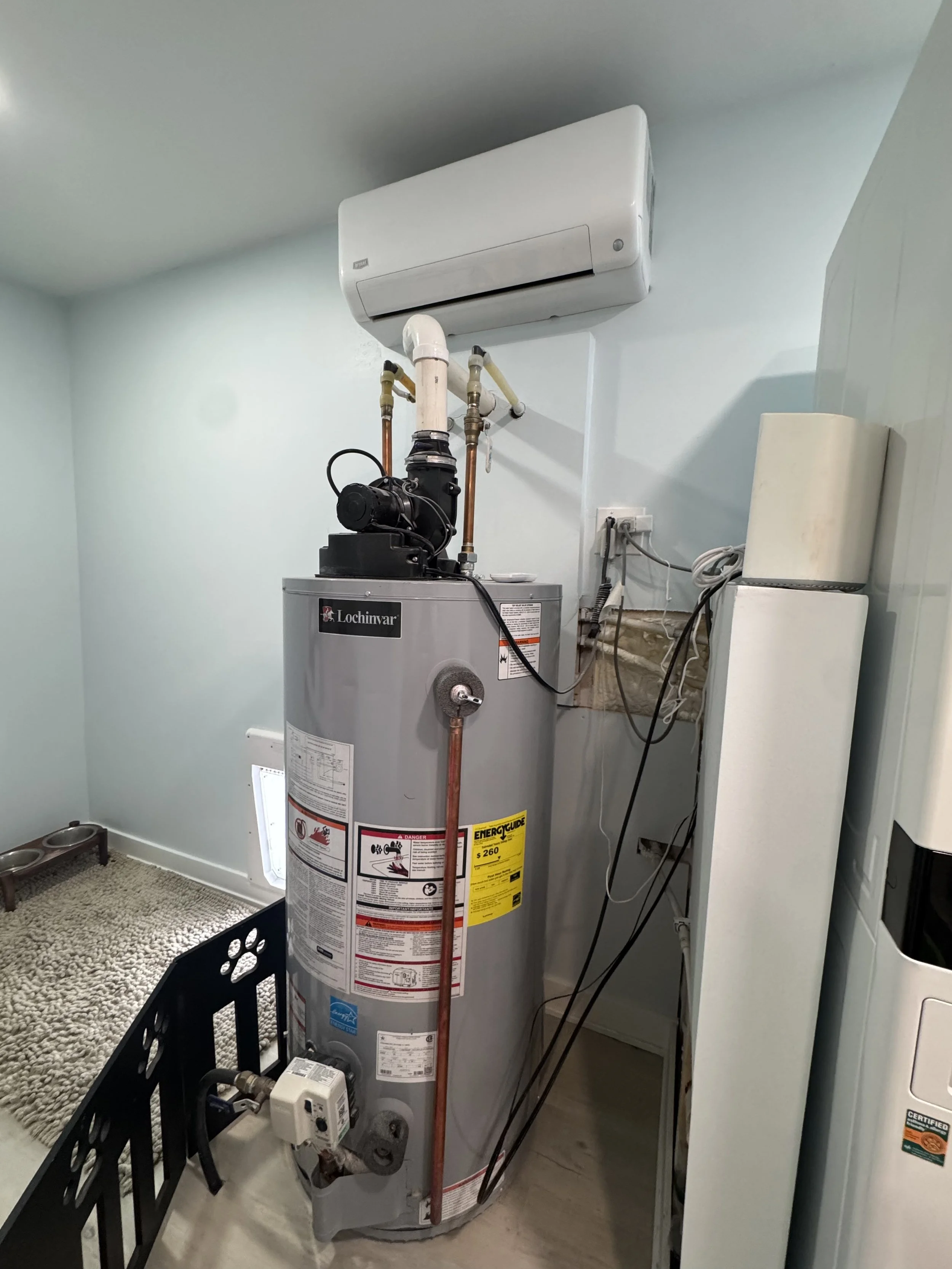 This is a utility room with a water heater and air conditioning unit.