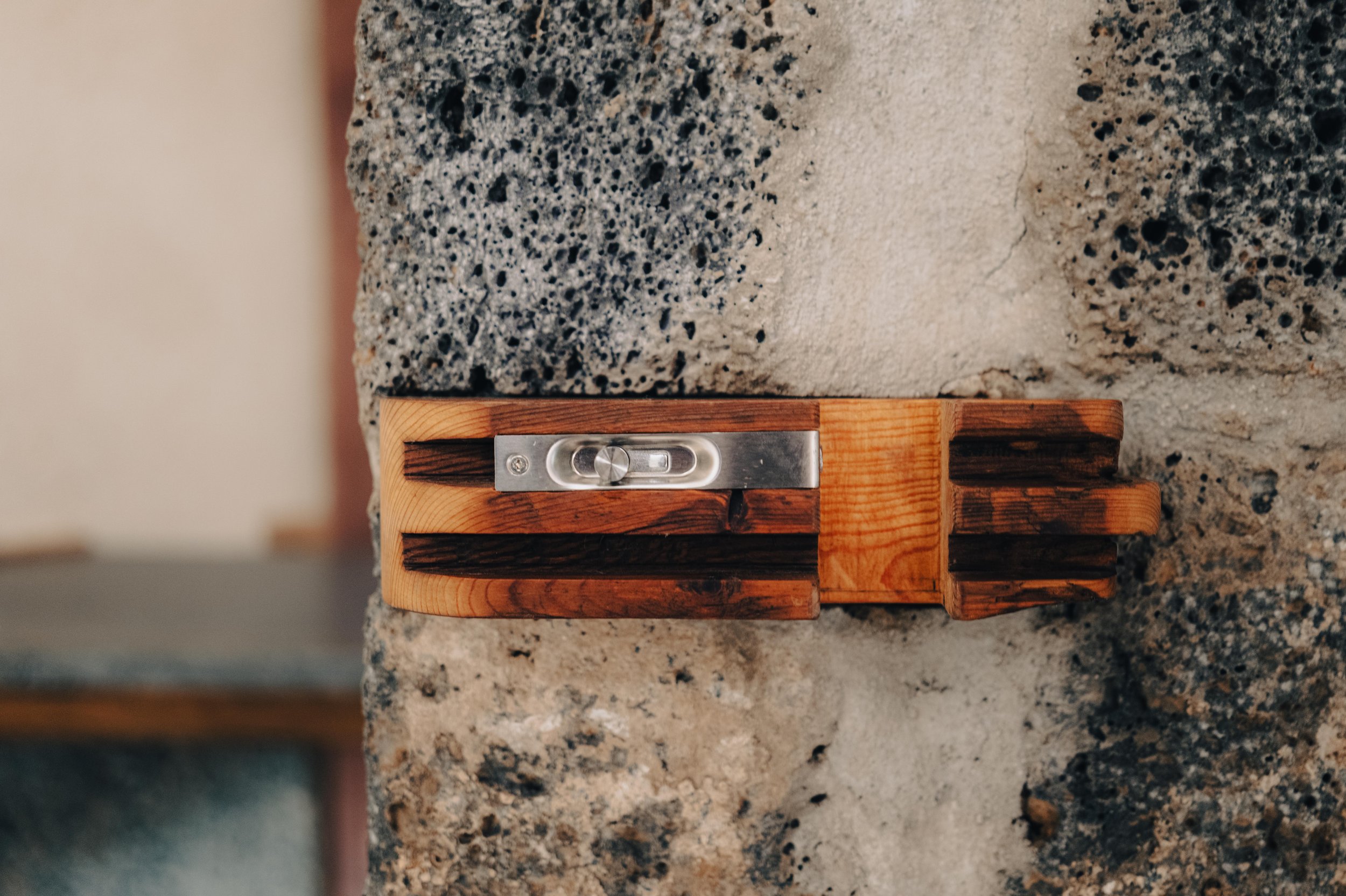 NUUT Aewol 눗애월 Wooden spirit level placed on a textured concrete surface.