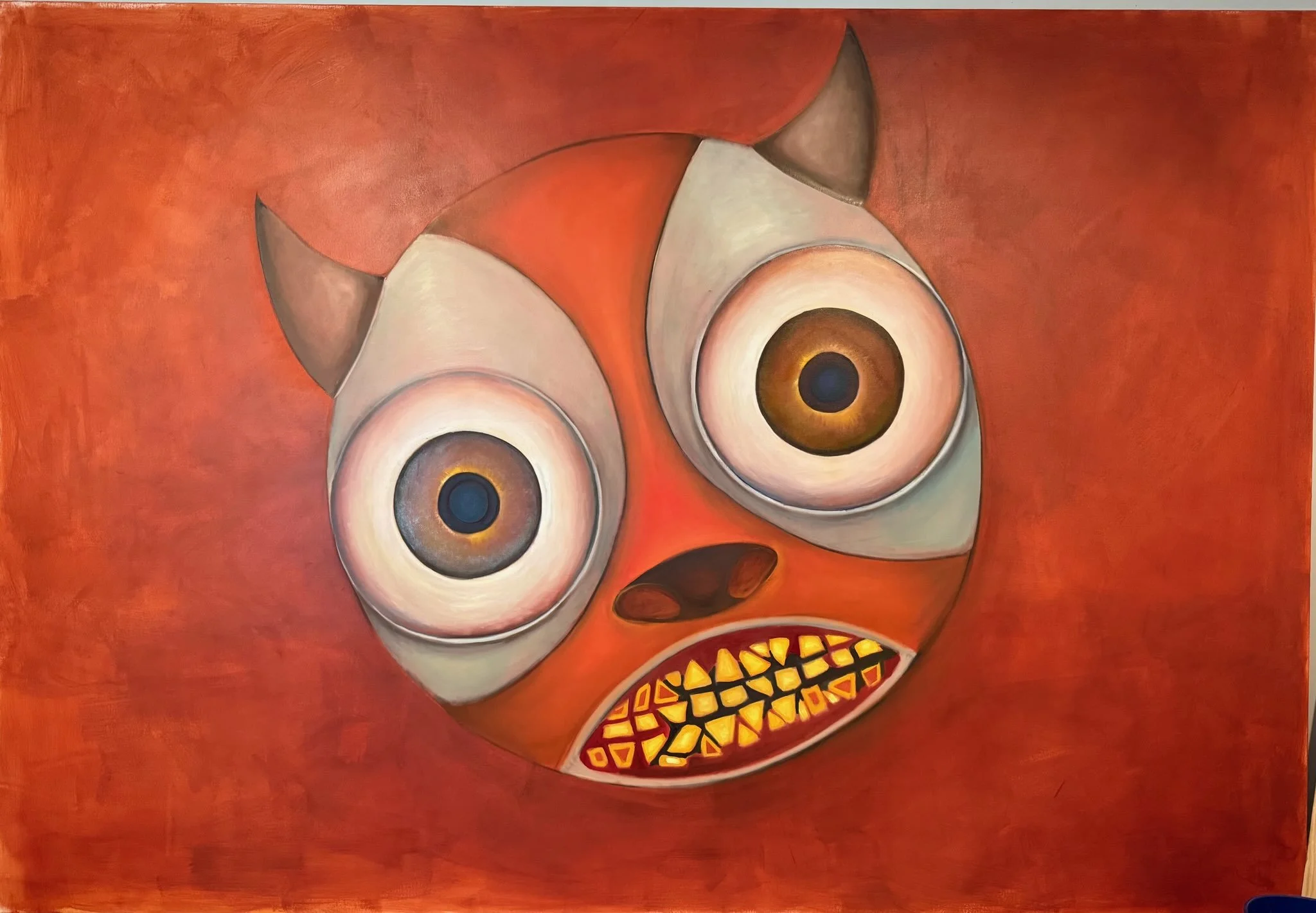 Abstract painting of a face with large eyes, a nose, and an open mouth showing yellow, orange, and red teeth, on a red background.