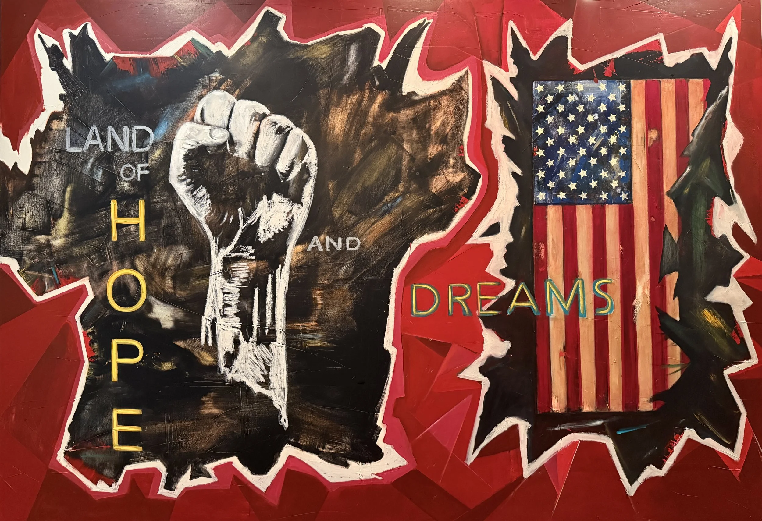 A colorful mural depicting a clenched fist on the state of Michigan outline, with the words 'LAND OF HOPE AND DREAMS' and a stylized American flag on the right side.