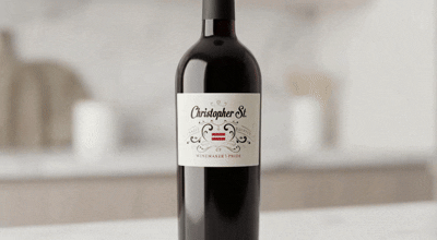 Bottle of red wine on a kitchen counter with blurred background.