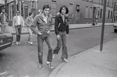 Group of people walking on a city sidewalk, black and white photo