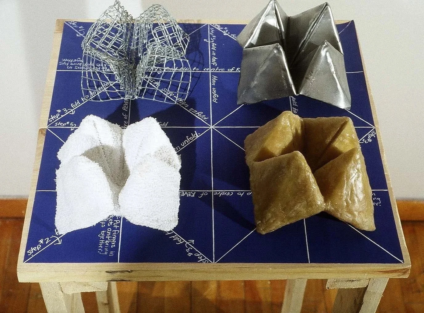 Multiple Choice: Before. Blueprint, cloth, wire, wax, folded steel, wood table. 2003