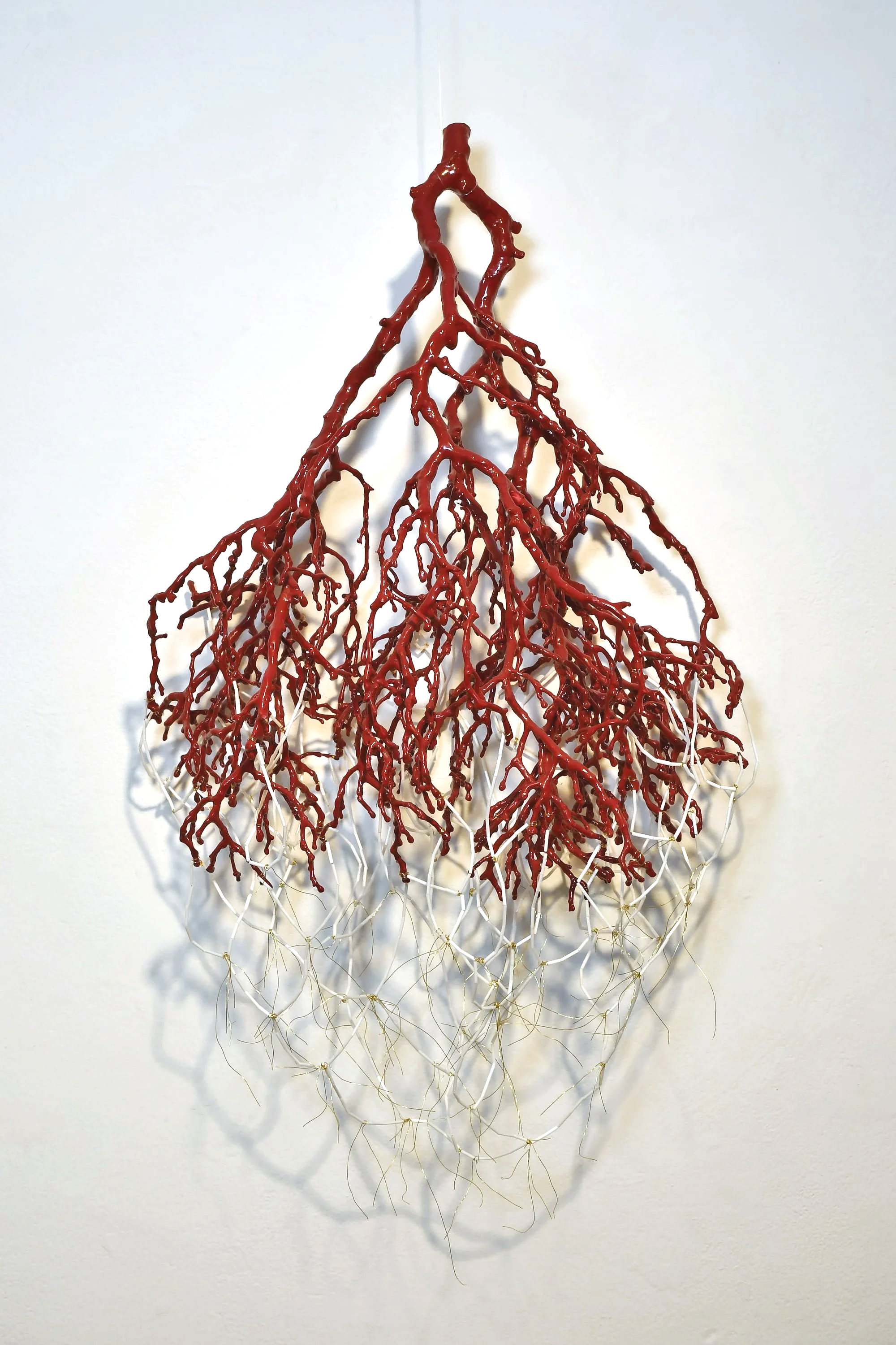 My Own Fish and Blood. Arbutus branch, wax, spraypaint, wire, glass beads. 2025-2026.