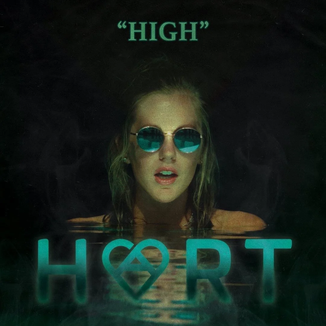 A woman with blonde hair wearing round sunglasses with blue lenses, partially submerged in water, with the word 'HOPE' written in large blue letters at the bottom, and the word 'HIGH' in quotation marks at the top.
