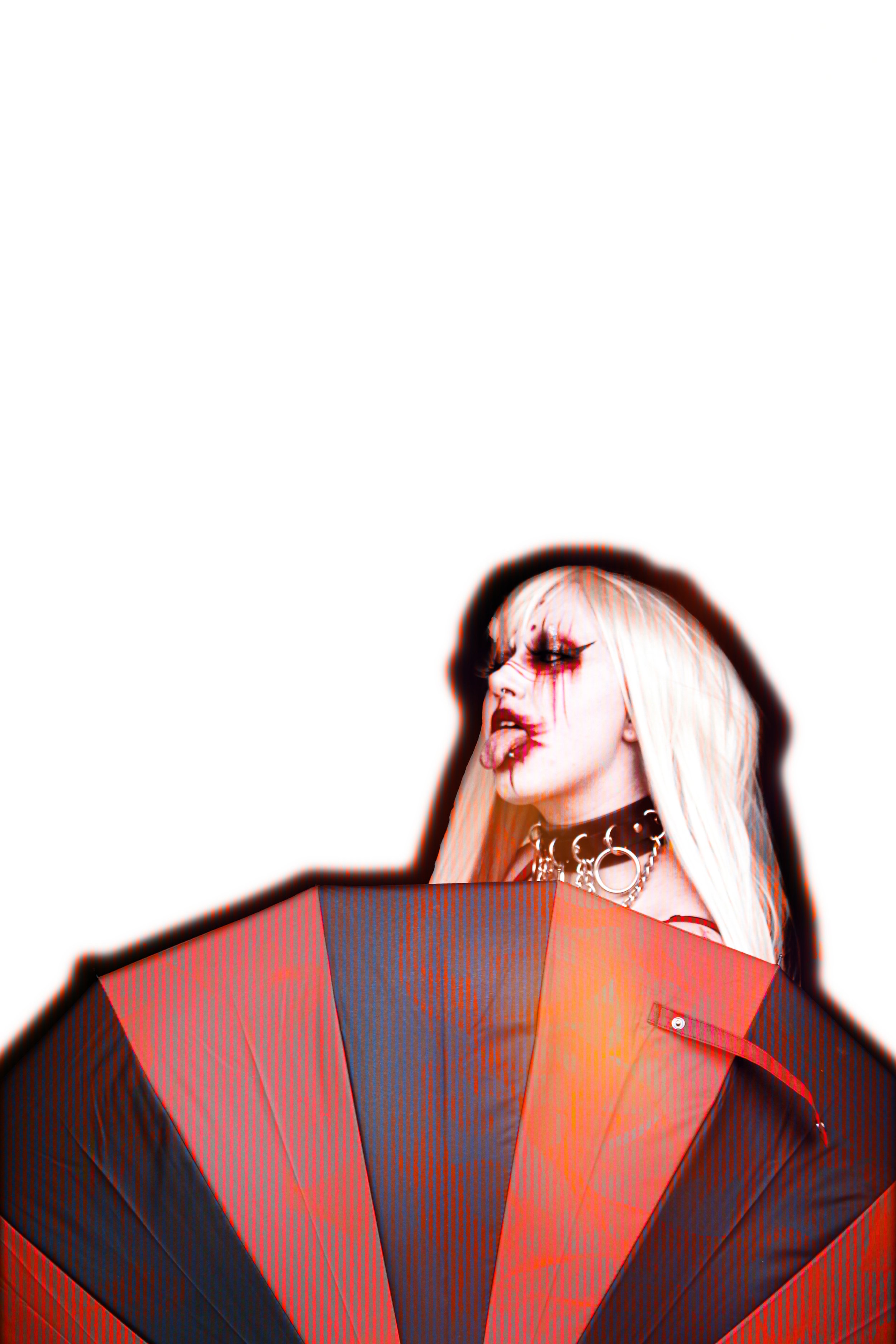 A person with long blonde hair, gothic makeup, black lipstick, dark eye makeup, red and black eyeshadow, wearing a black choker with silver rings, sticking out their tongue, with red and black streaks of makeup on their face, holding an orange and re