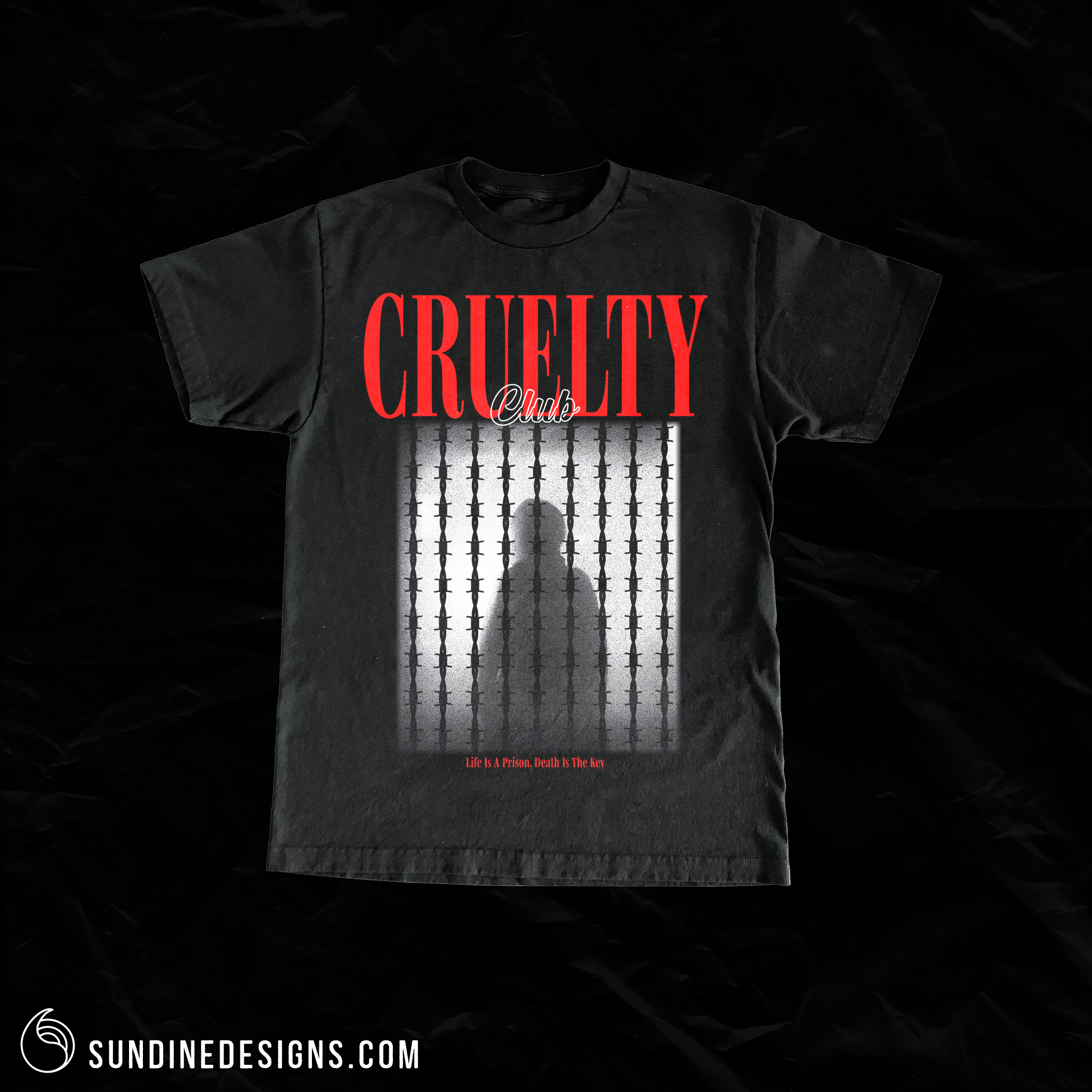 Black T-shirt with red and white text reading 'Cruelty Club' and a graphic of a silhouette behind prison bars, with a small red phrase at the bottom saying 'Life is a Prison, Death is the Key.'